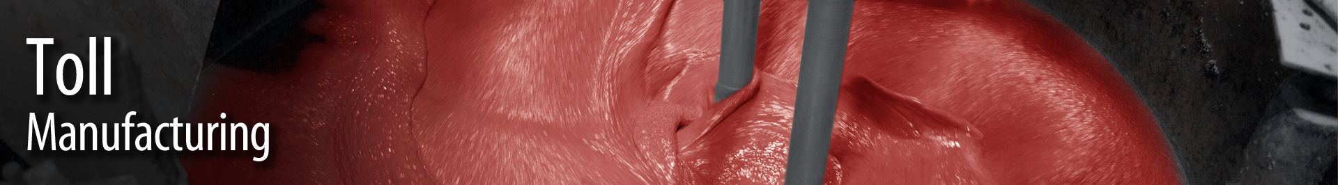 Close-up view of raw meat being processed in a manufacturing setting, with two metal tools inserted into the meat.