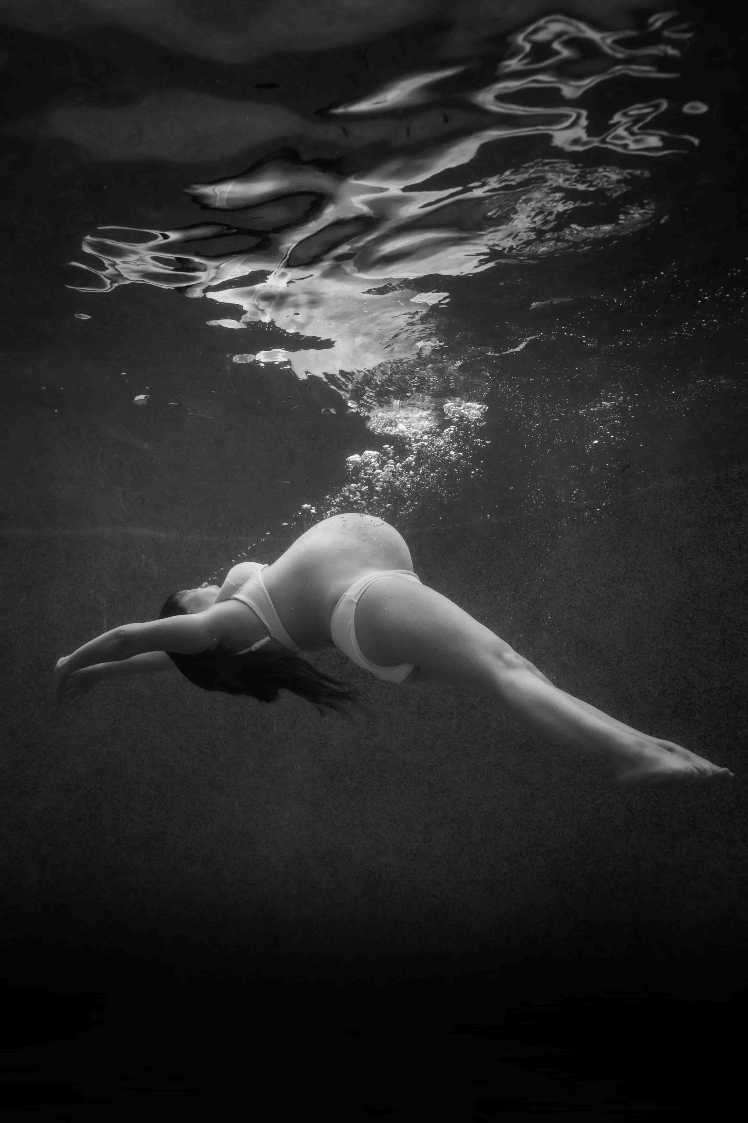 A pregnant woman floating in the water