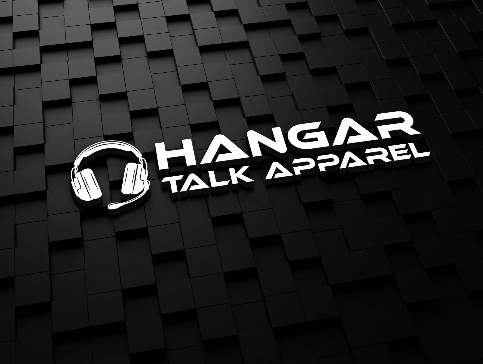 Black geometric wall with illuminated white sign that says 'HANGAR TALK APPAREL' and an outline of headphones.