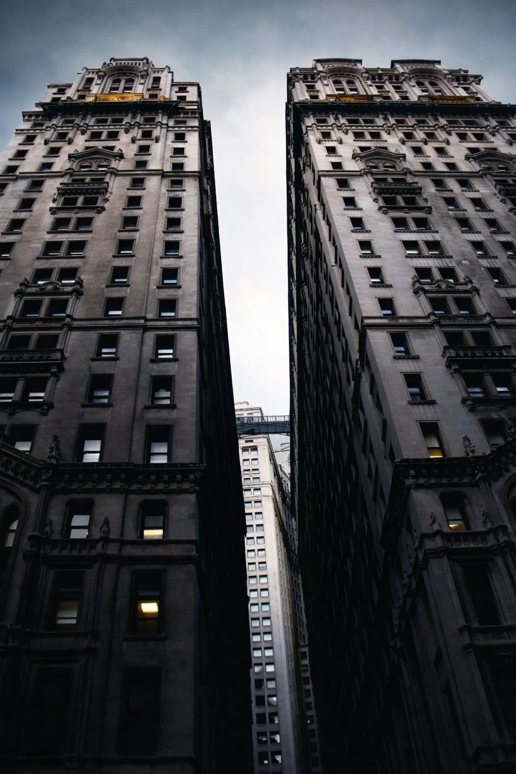 "Between Them"
The buildings rise on either side, narrowing the sky to a line. The space between becomes as important as what surrounds it.