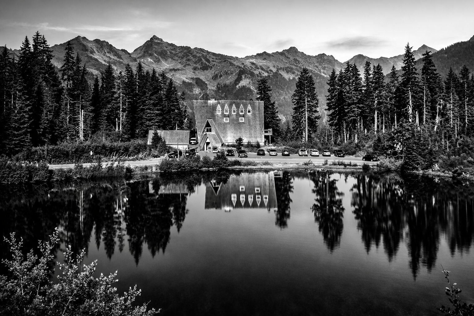 "Echoes in Reflection"
Mountains settle into the water as if remembering themselves. The world duplicates in silence, untouched by interruption.