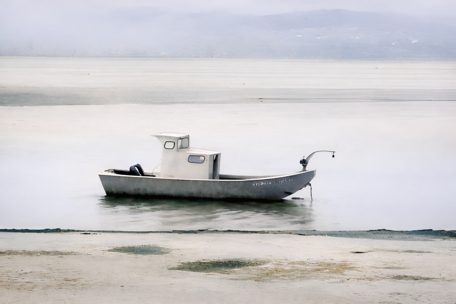 "Untethered"
A boat rests near shore, neither departing nor arriving. The water holds it in place, as if waiting for a decision never made.