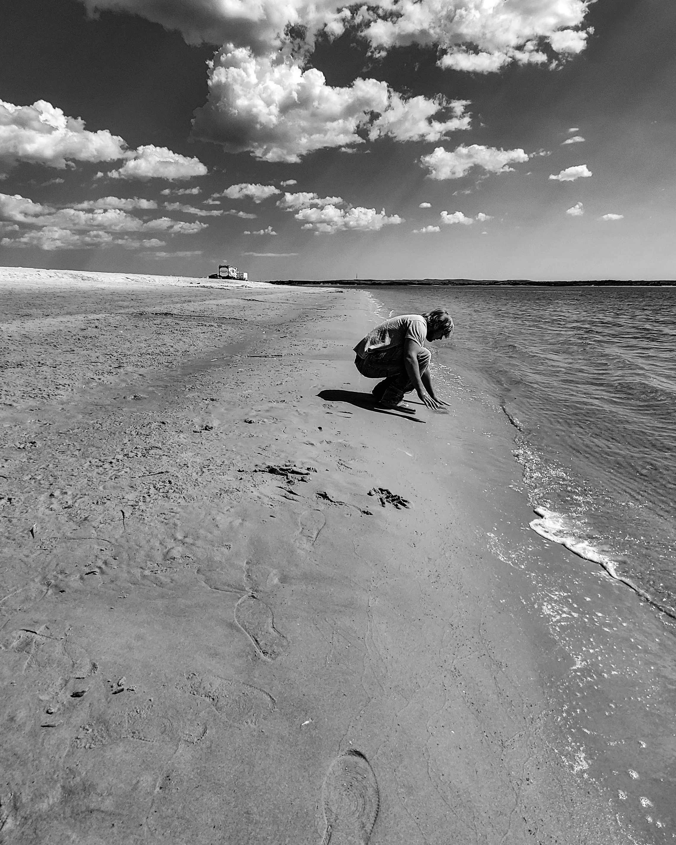 "Along the Edge" No urgency, held between land and water. The moment drifts with him.