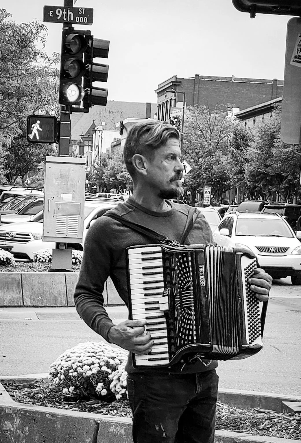 "Street Song"
He plays into the open air, offering something that may or may not be heard. The moment exists whether it’s received or not.
