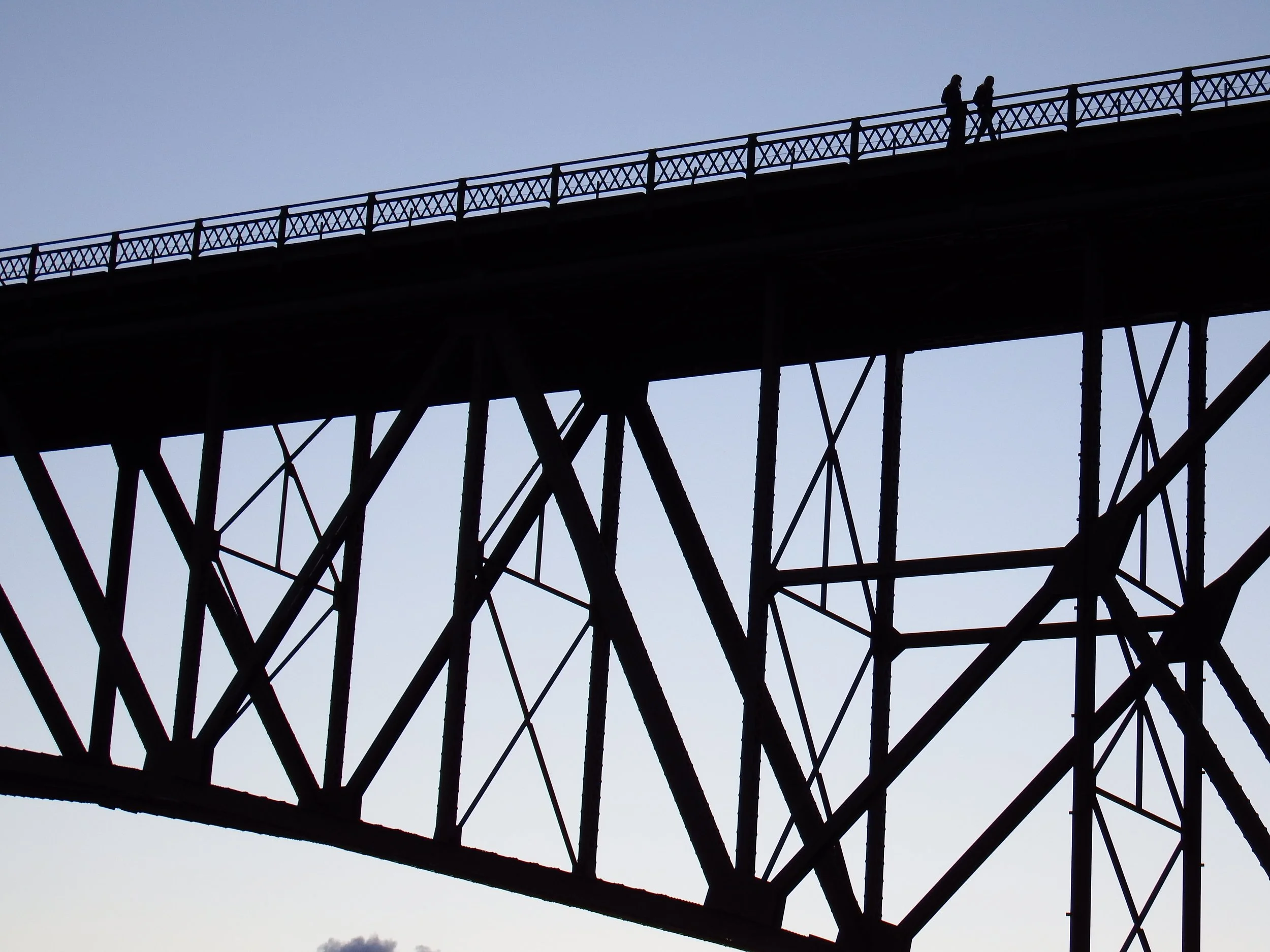 "Crossing Lines"
Figures move across the bridge in quiet procession. The path holds them, carrying them forward together.