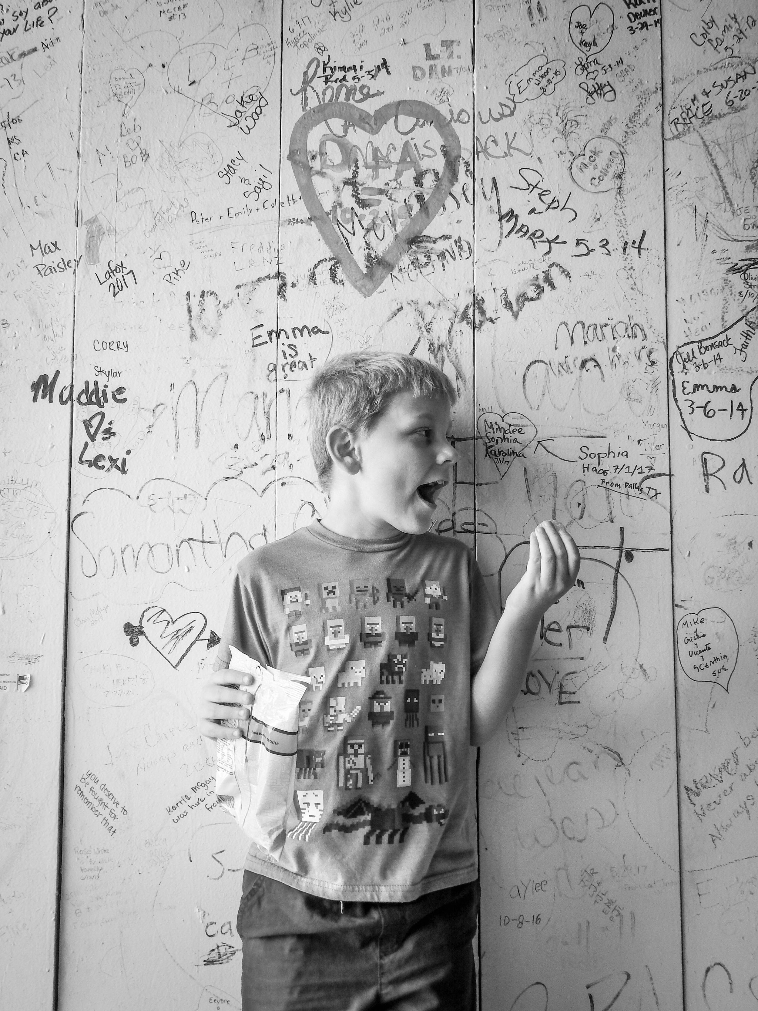 "Occupied"
He stands close to the wall, focused only on the chips in his hand. The moment is simple, self-contained, and entirely his.