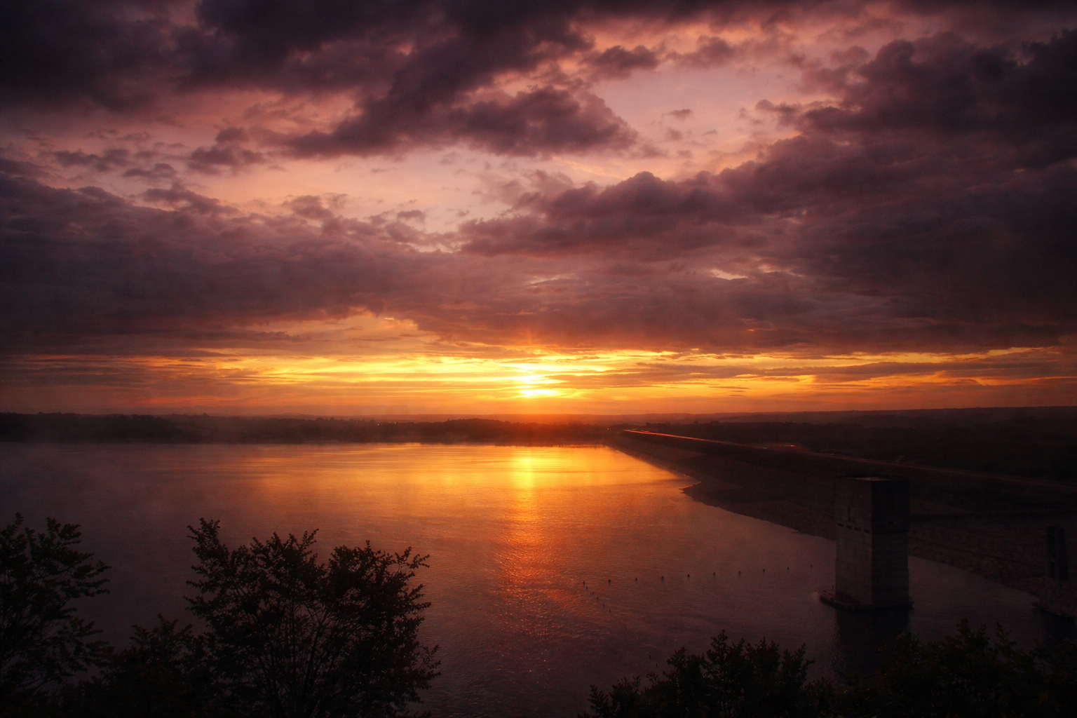 "Last Light, Held"
The sun rests on the horizon as if unwilling to leave. Time slows here, stretching the final moment into something permanent.