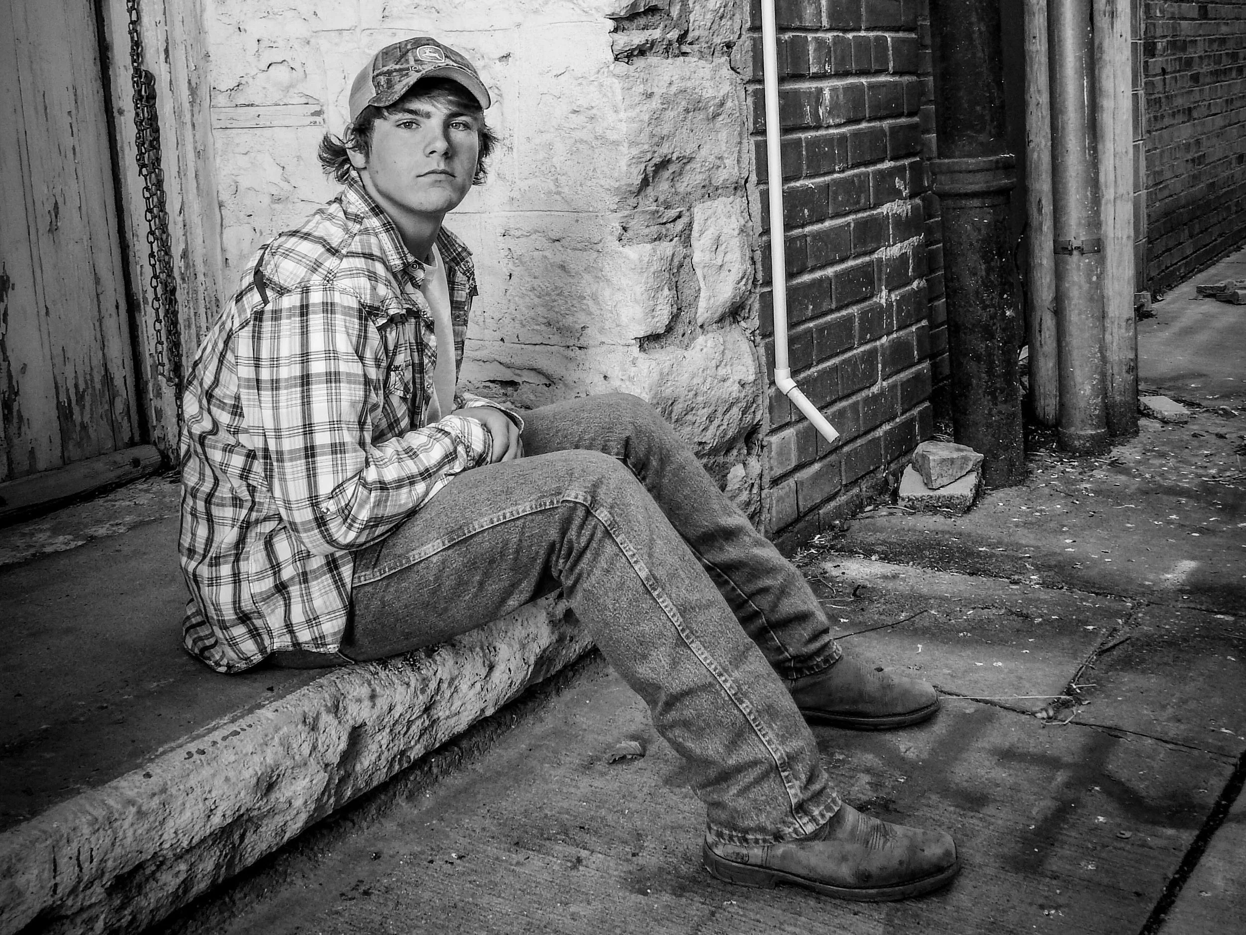 "Set Apart"
He sits against the wall, separate from whatever surrounds him. The moment feels held—quiet, but not empty.