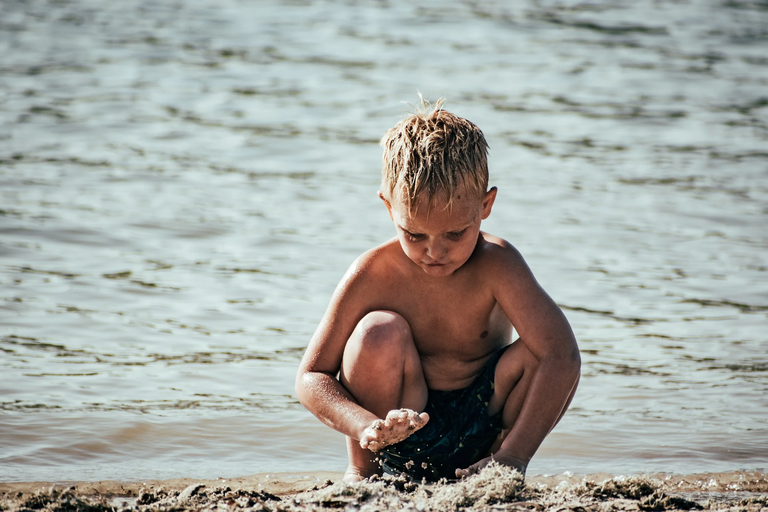 "Small Hands, Big World"
He studies the water as it slips through his fingers, fully absorbed in something simple and endless. The moment belongs entirely to him.