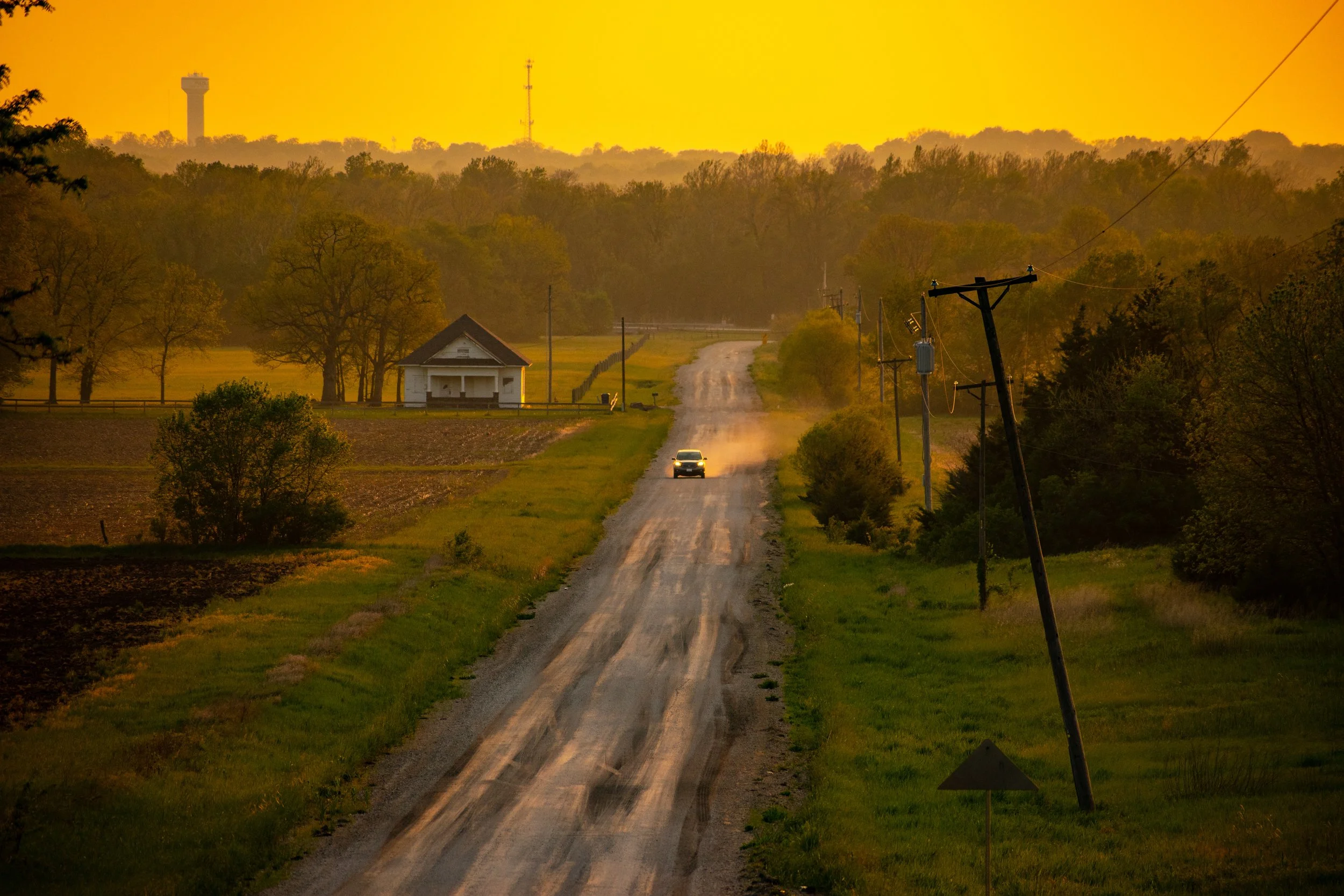 "The Way In"
The road leads through open land toward something lived-in and familiar. It’s not just a path—it’s return.