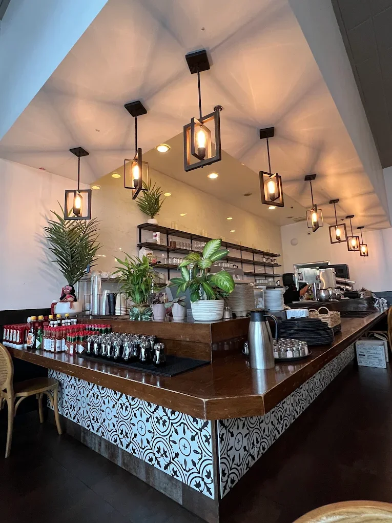Pink Hydrangea flowers in a clear glass vase on a table.