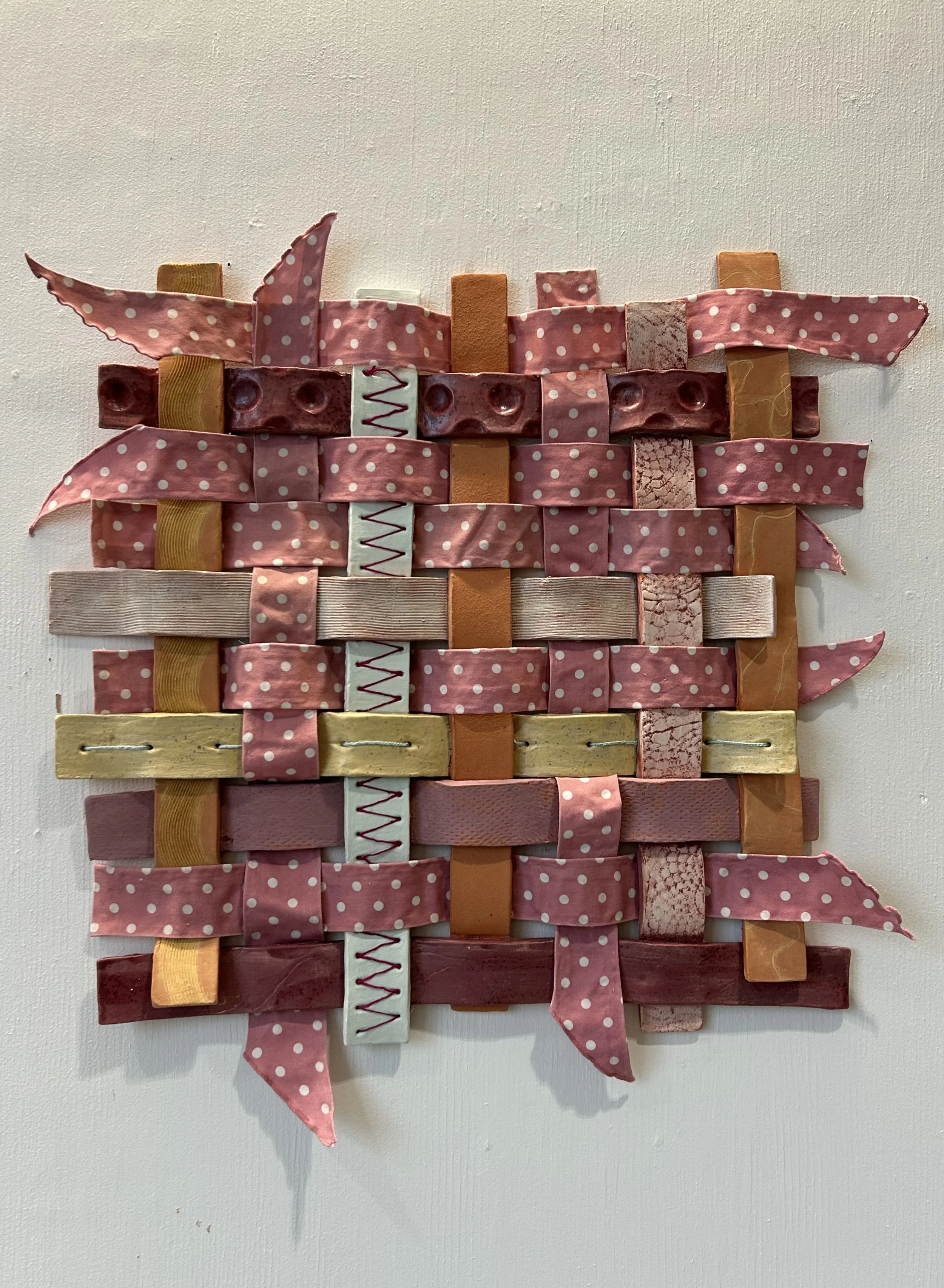 "Ceramic Weaving", 2025, Ceramic, Fabric, Fabric Stiffener, and Thread, 27in x 27in.
