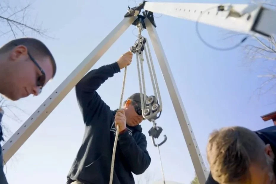 IMET installers preparing a winch for installation of "drop-in" modular wastewater treatment technology