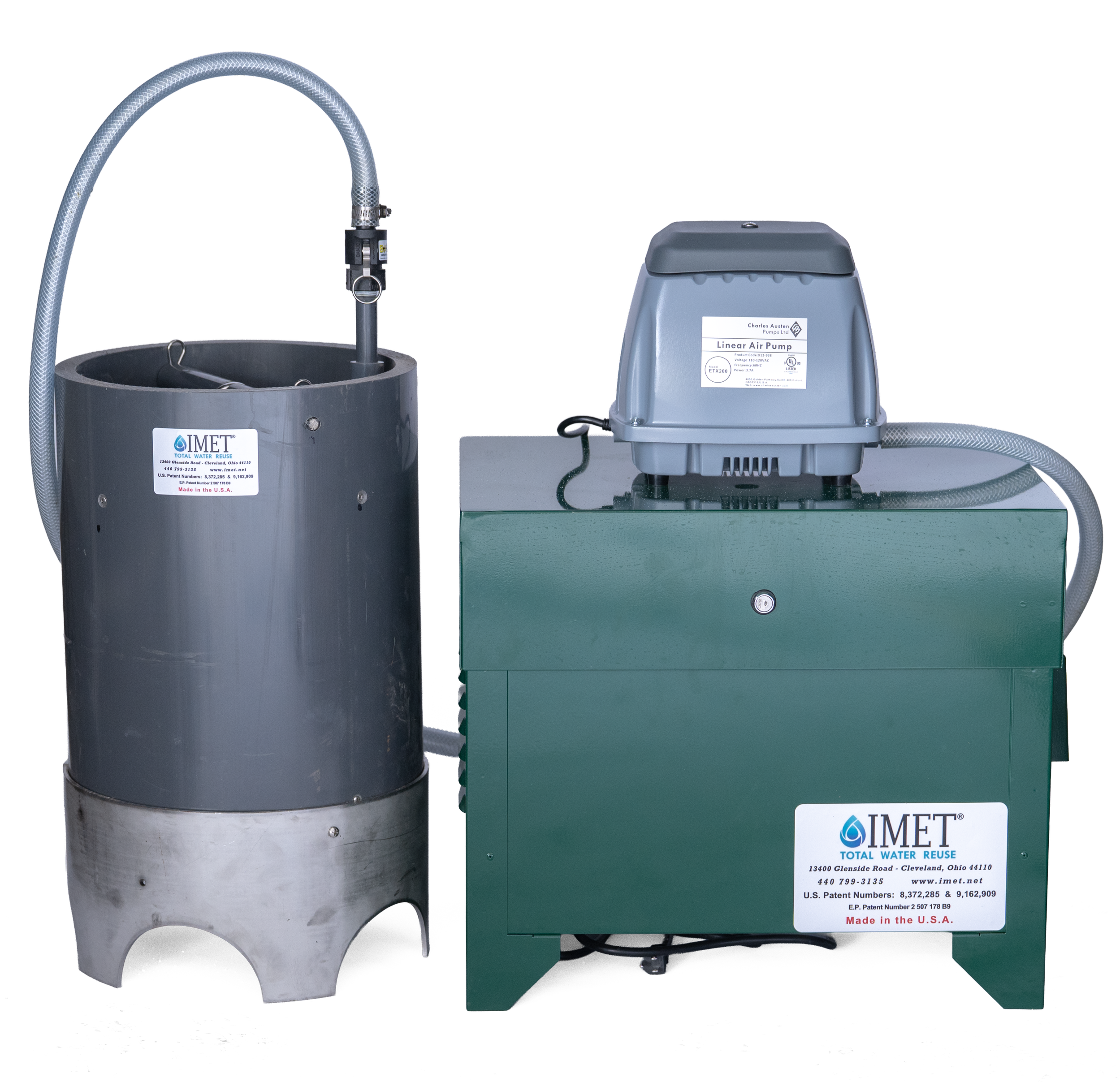 A wastewater treatment system with a gray cylindrical tank on the left, connected to a green air pump container on the right, labled IMET Total Water Reuse.
