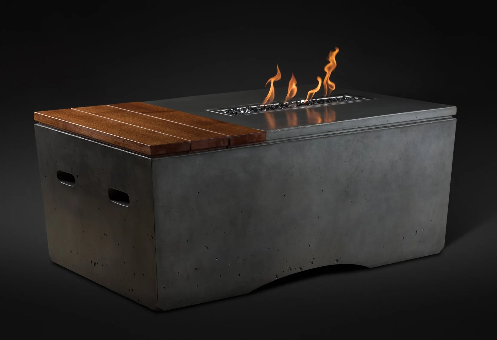 a rectangular fire pit with a concrete base, with a metal top surface where flames are rising, and a wooden cover on one side