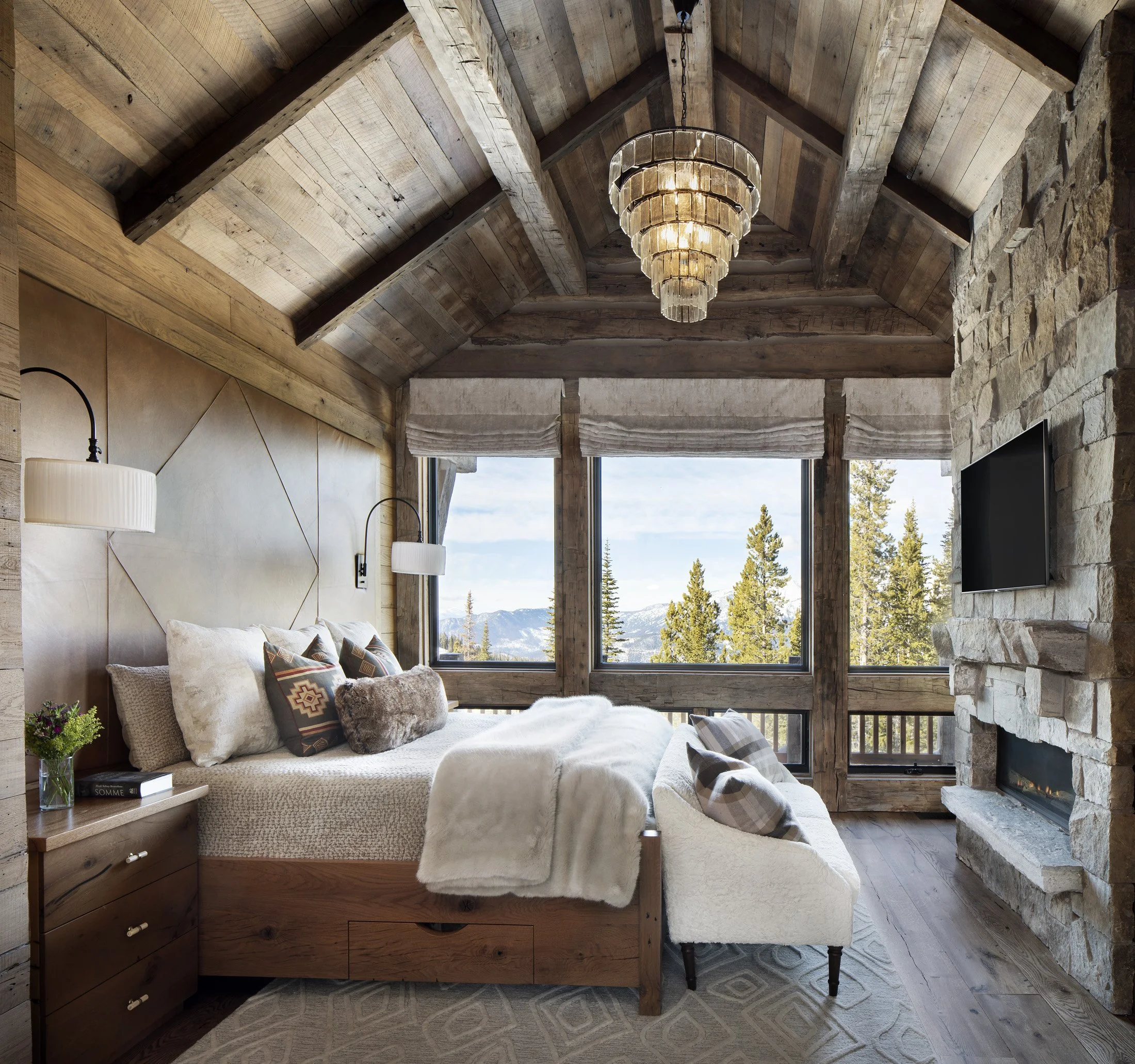 Bedroom with large window, timber framing, and mountain views in Moonlight Basin Montana