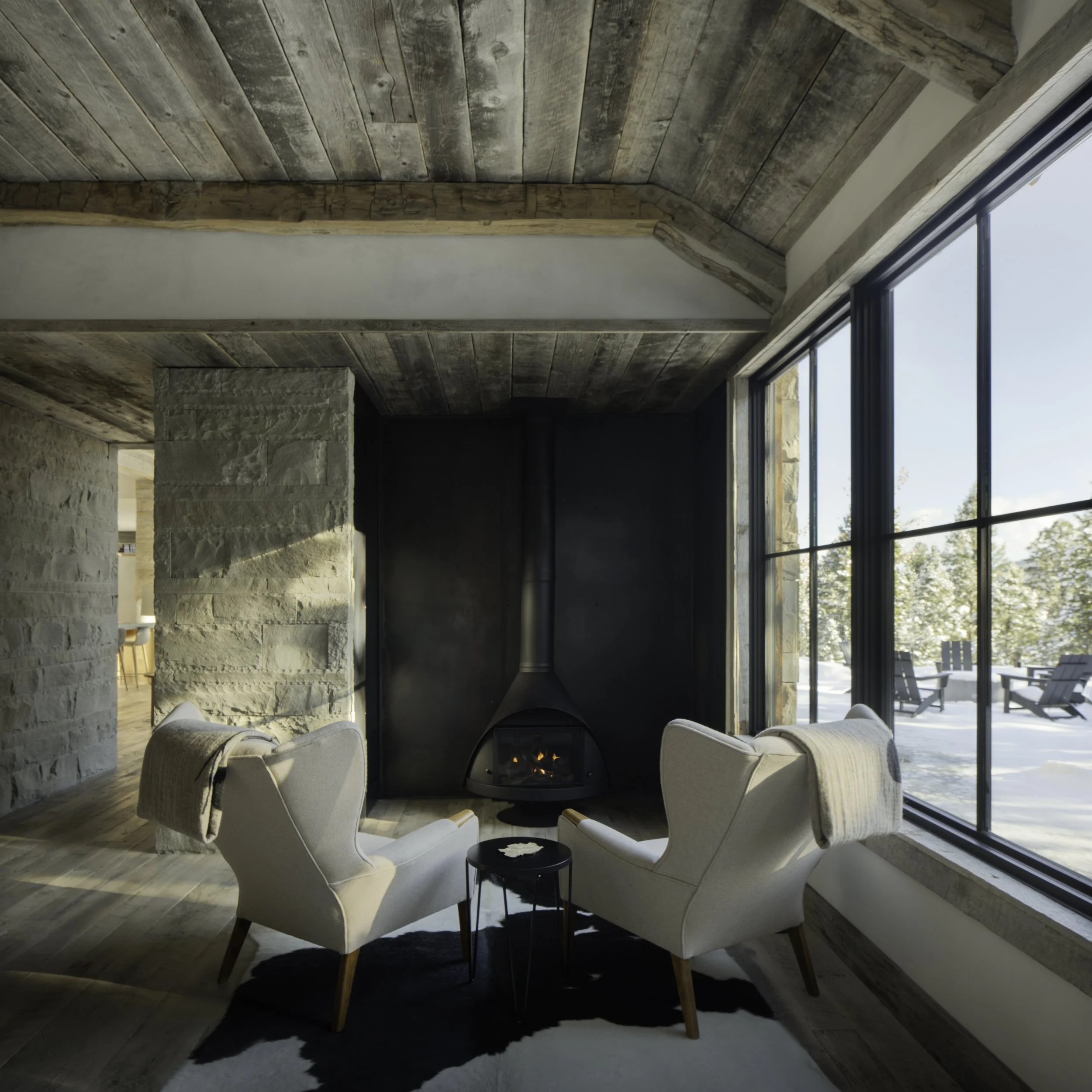  Living area with fireplace seating and large windows in Big Sky Montana
