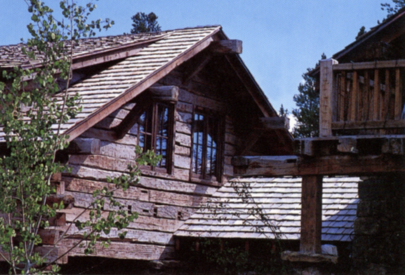 CW-10A-Hand-hewn log wall with gabled roof and divided light windows.png