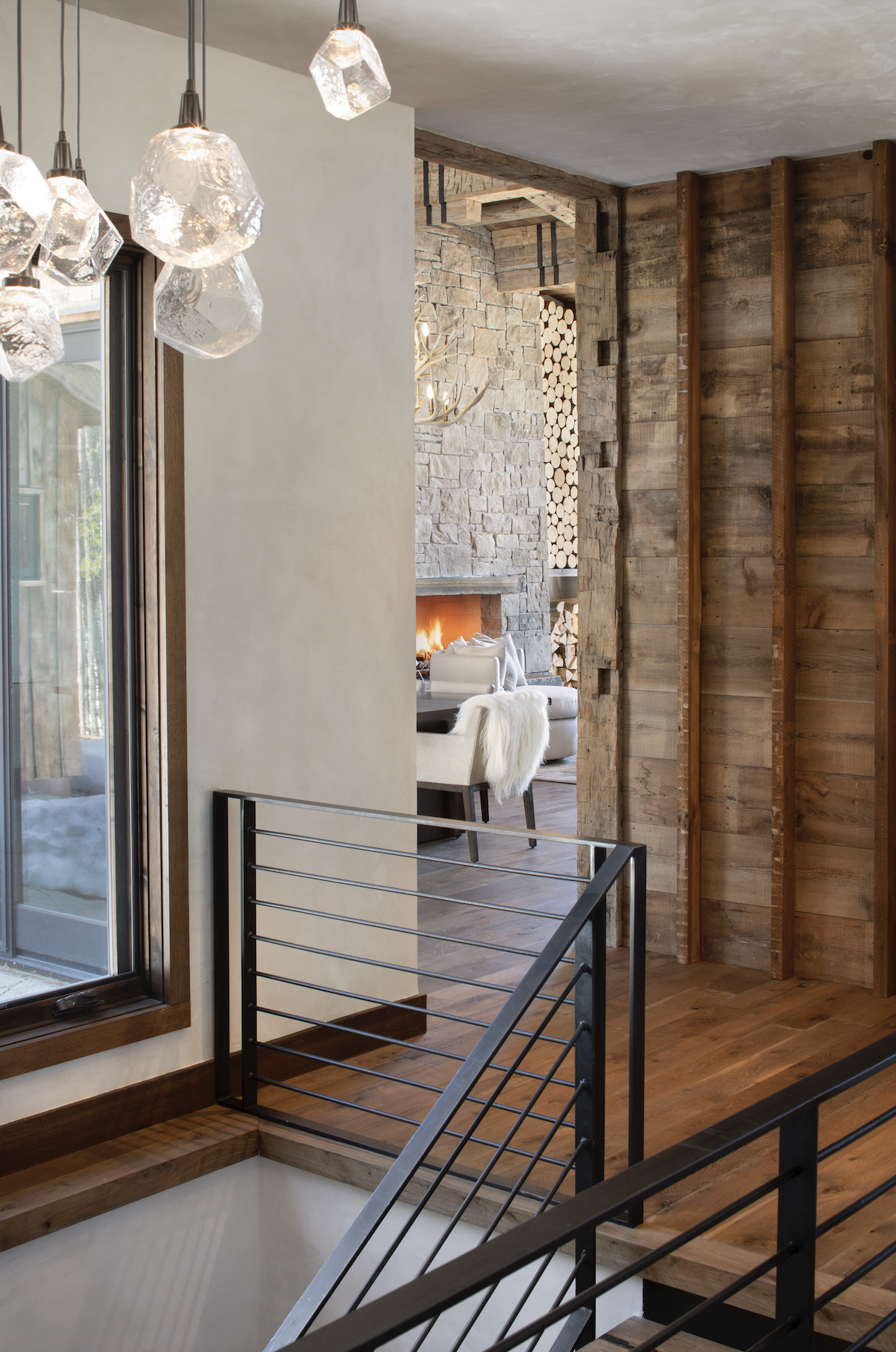 Stair detail featuring steel railing, thick wood treads, and exposed timber construction.