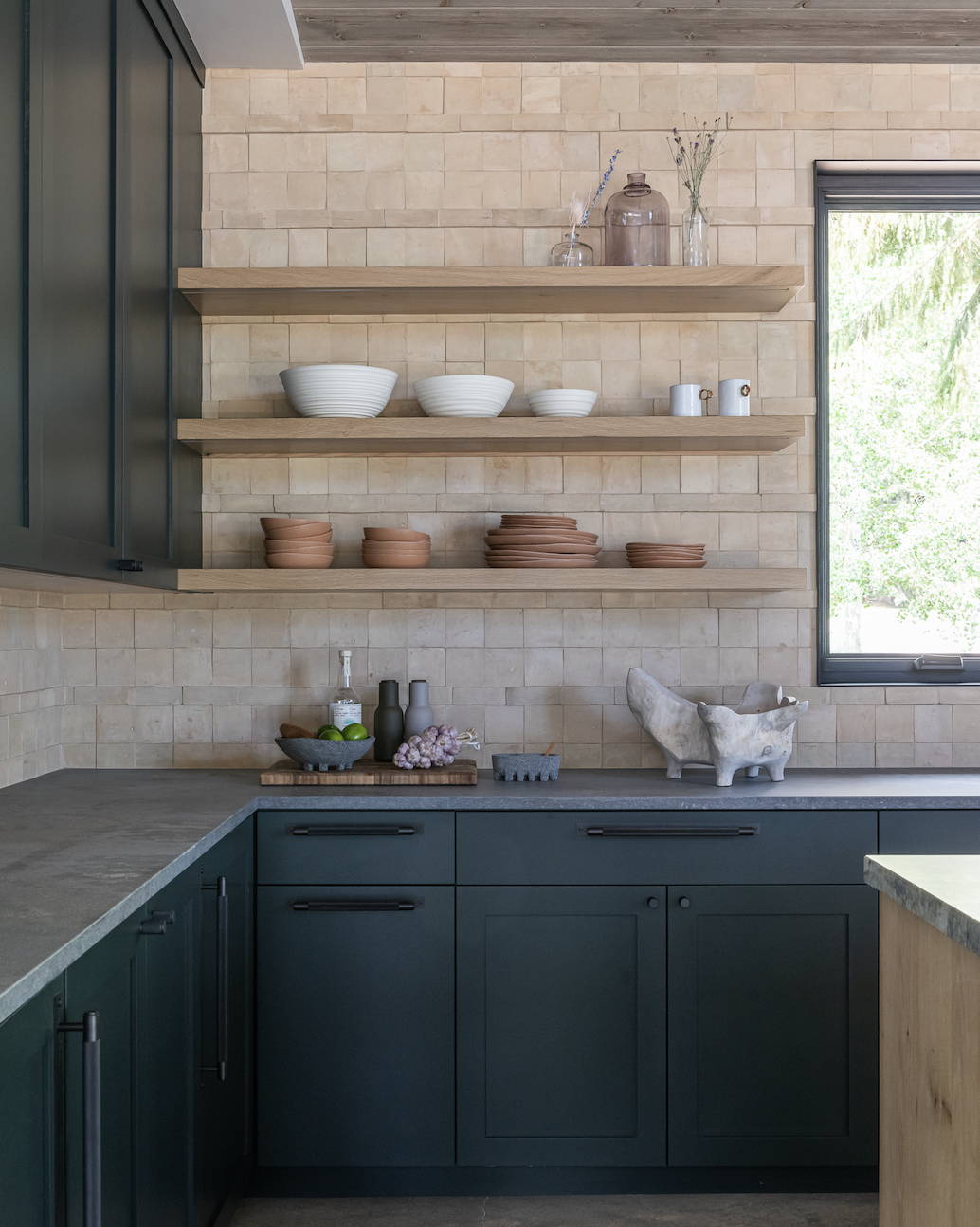 Kitchen with open wood shelving, tile backsplash, and cabinetry