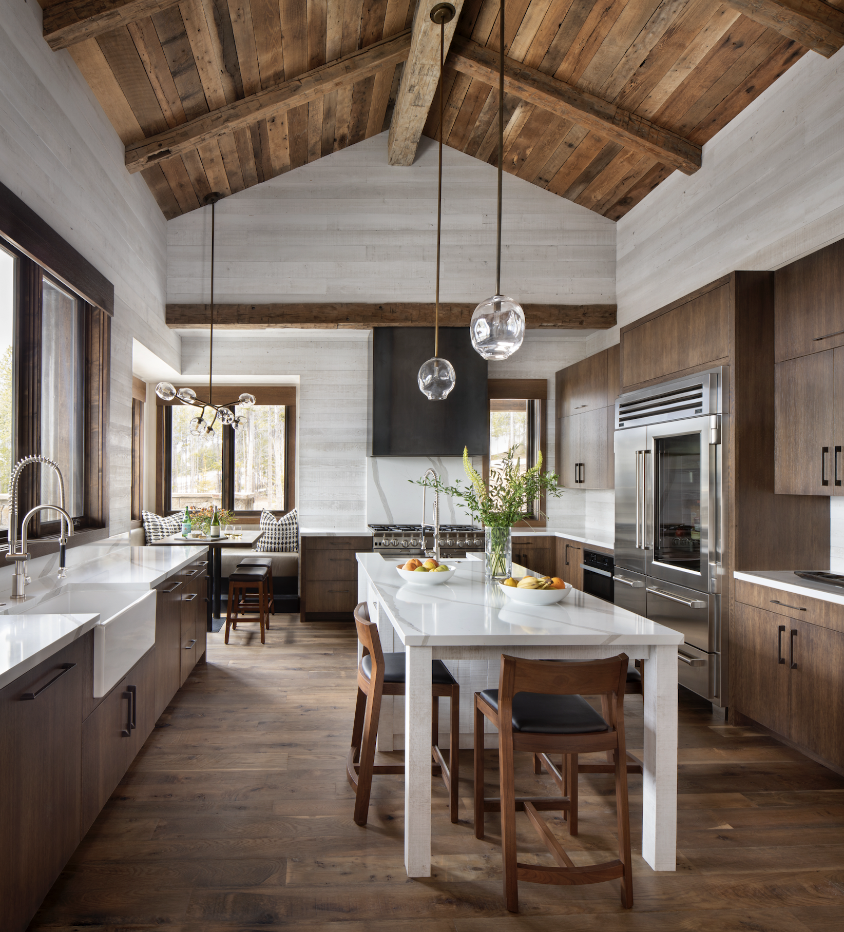 Kitchen with large island, wood cabinetry, vaulted ceiling, and breakfast nook.