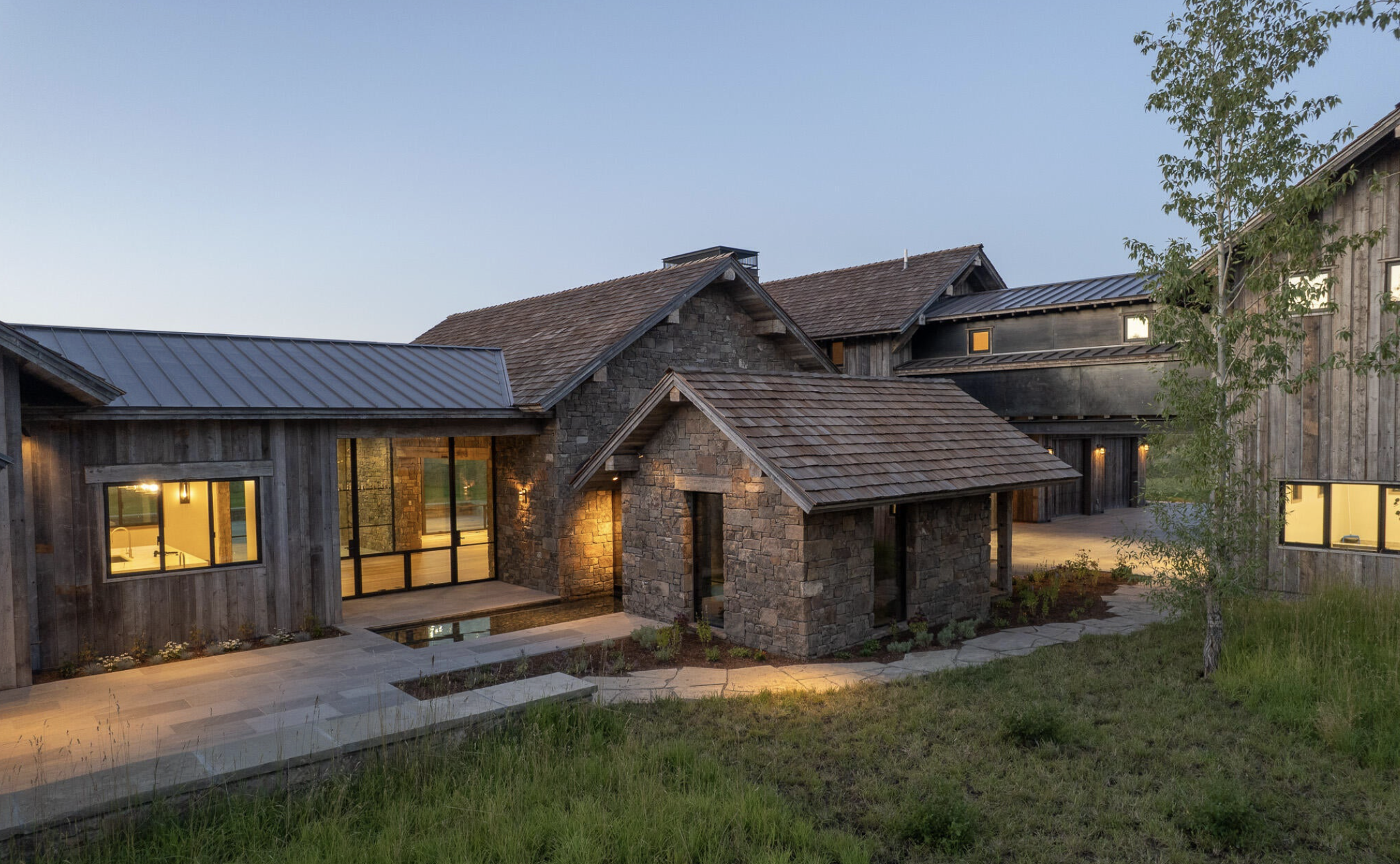 MP-01-front-entry-stone-courtyard-dusk.png