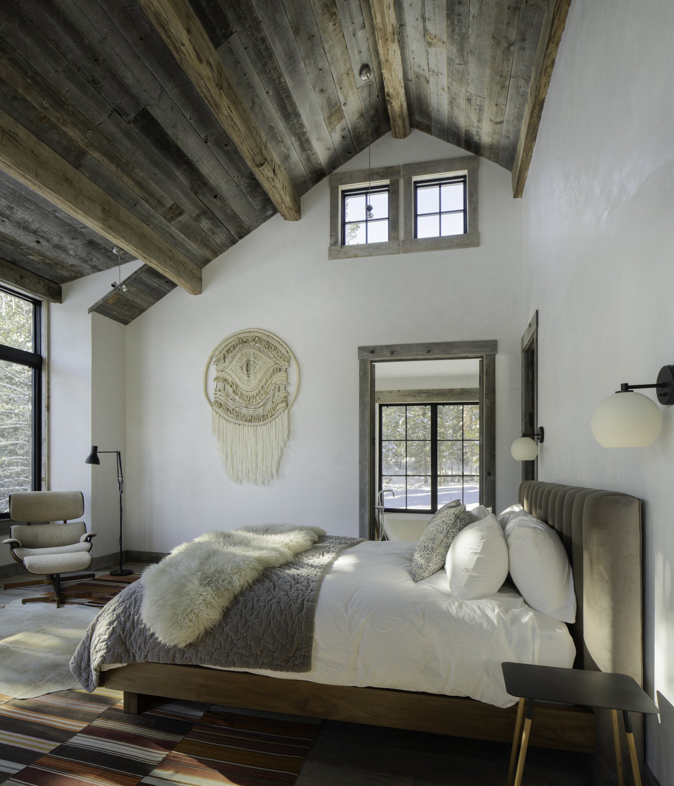 Primary bedroom with vaulted ceiling and wood beams in Big Sky Montana