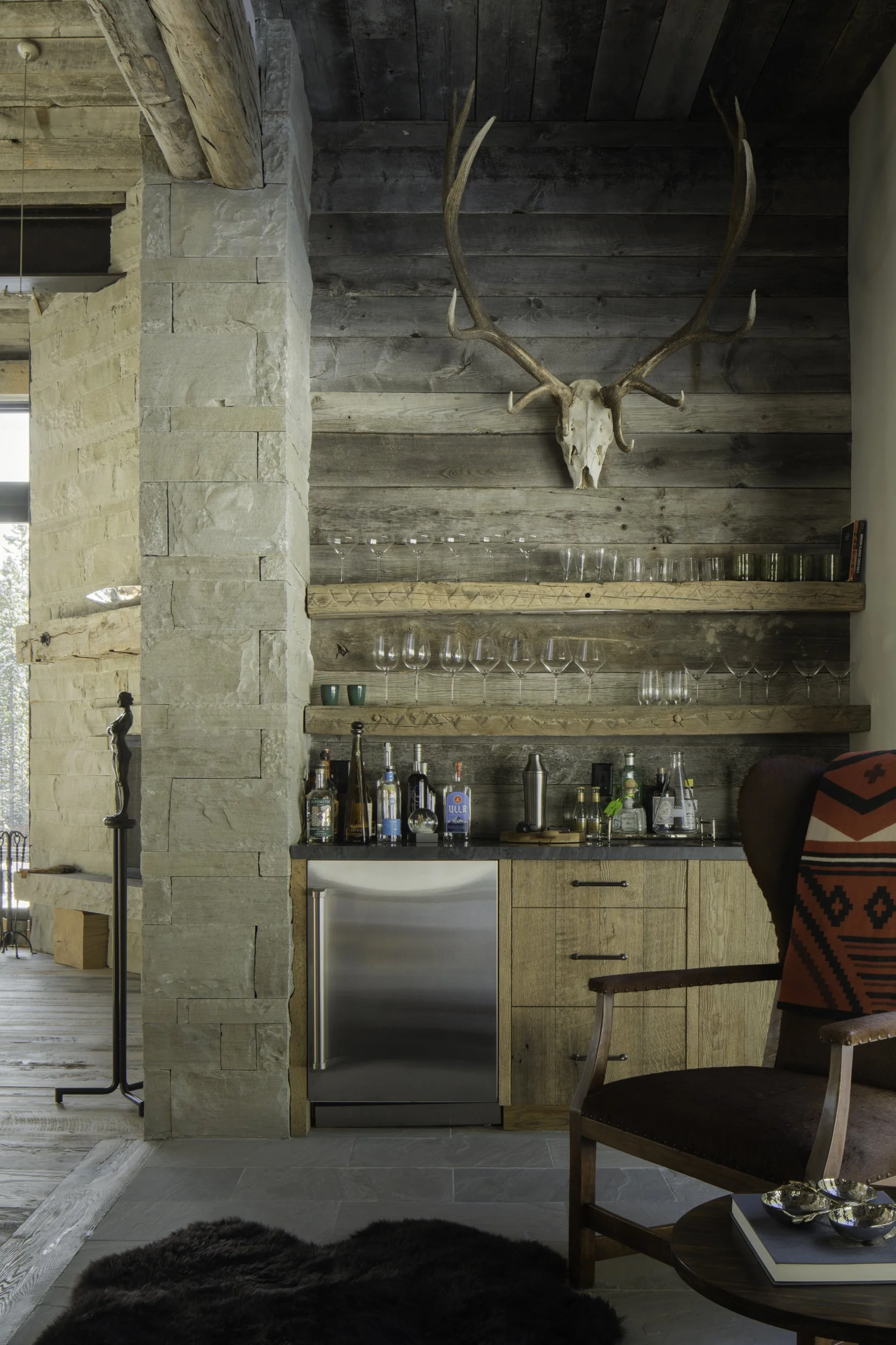 Built-in bar with wood shelving and antler detail in Big Sky Montana