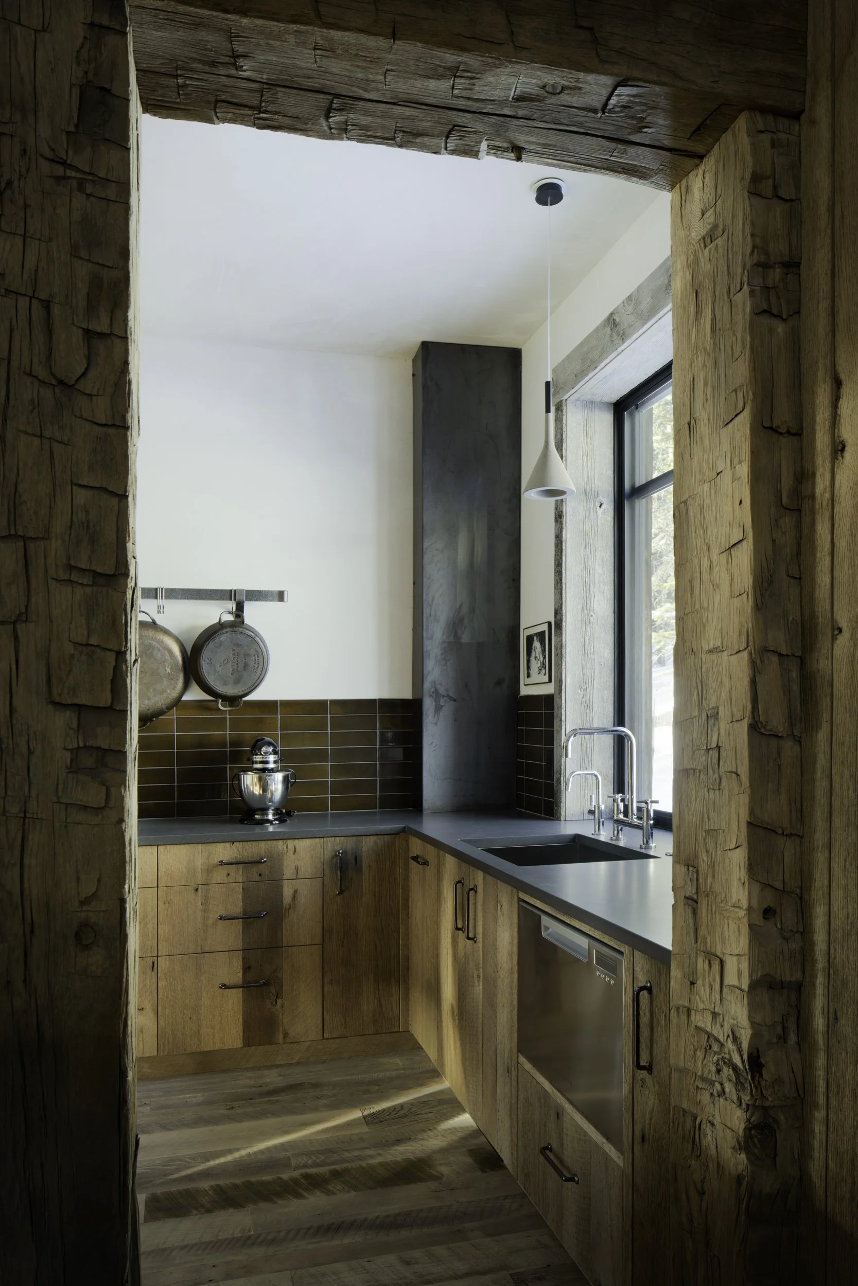 Pantry with reclaimed wood cabinetry and built-in storage in Big Sky Montana