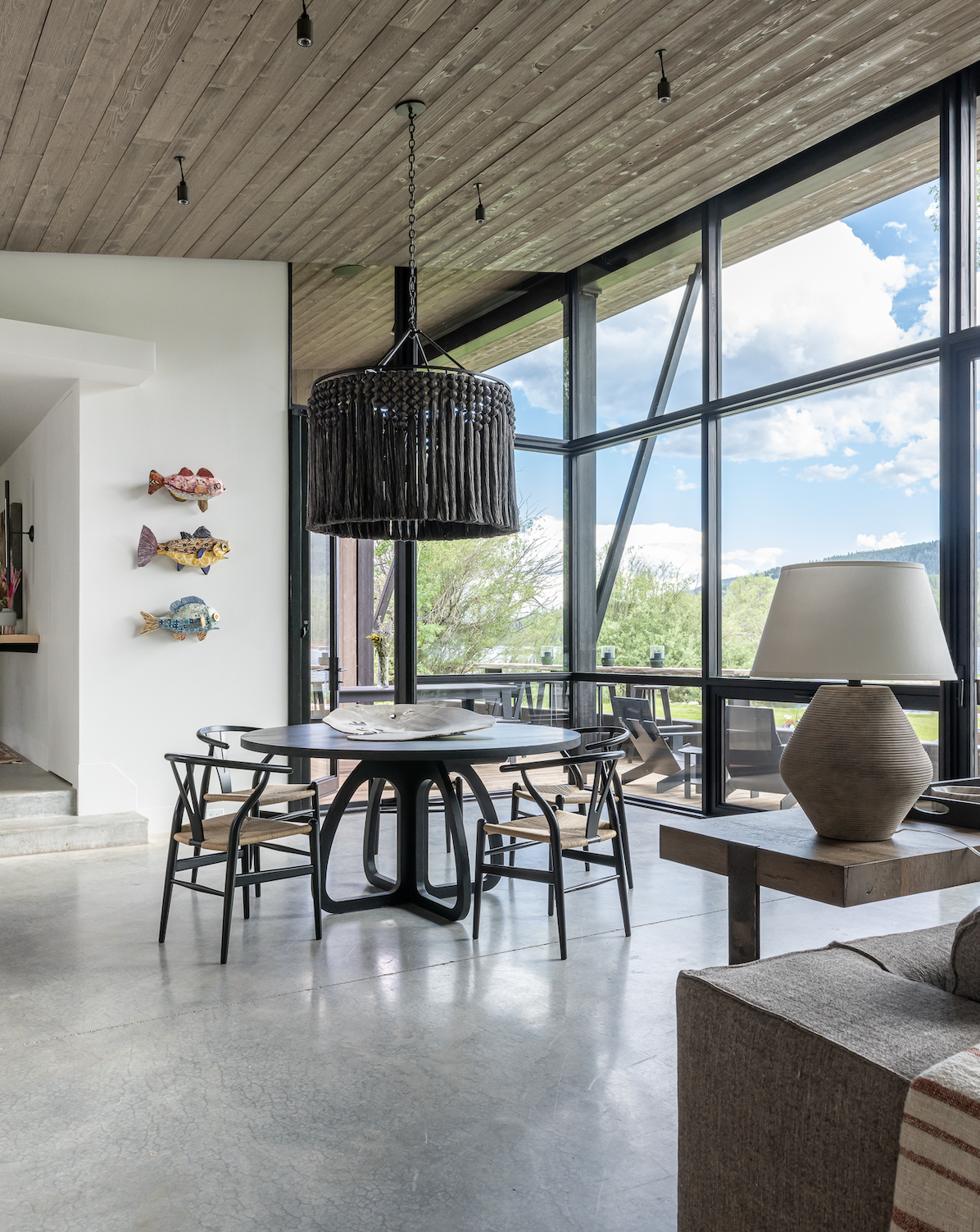 Dining area with floor-to-ceiling glass corner and lake views