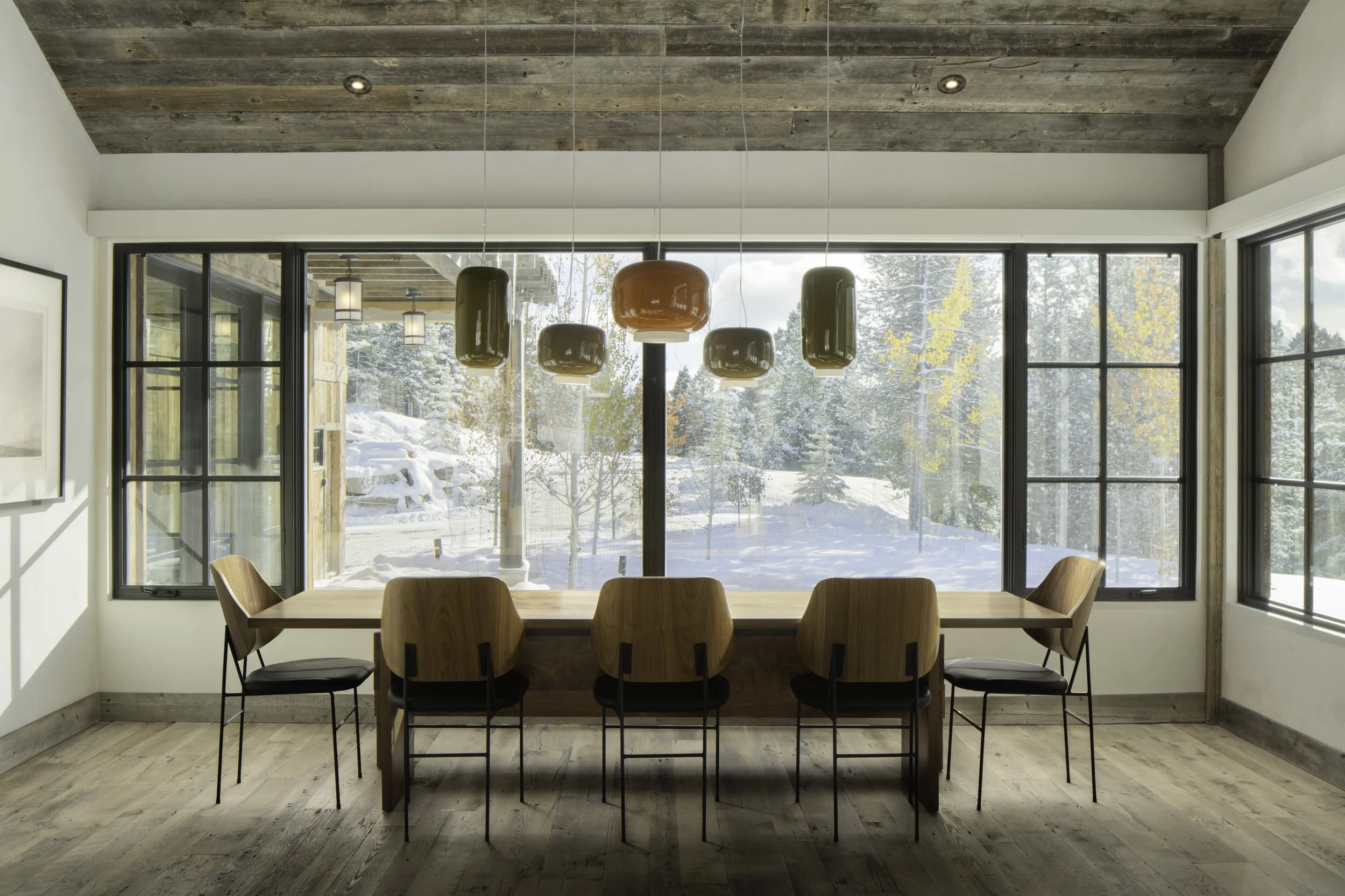 Dining room with large windows and forest views in Big Sky Montana