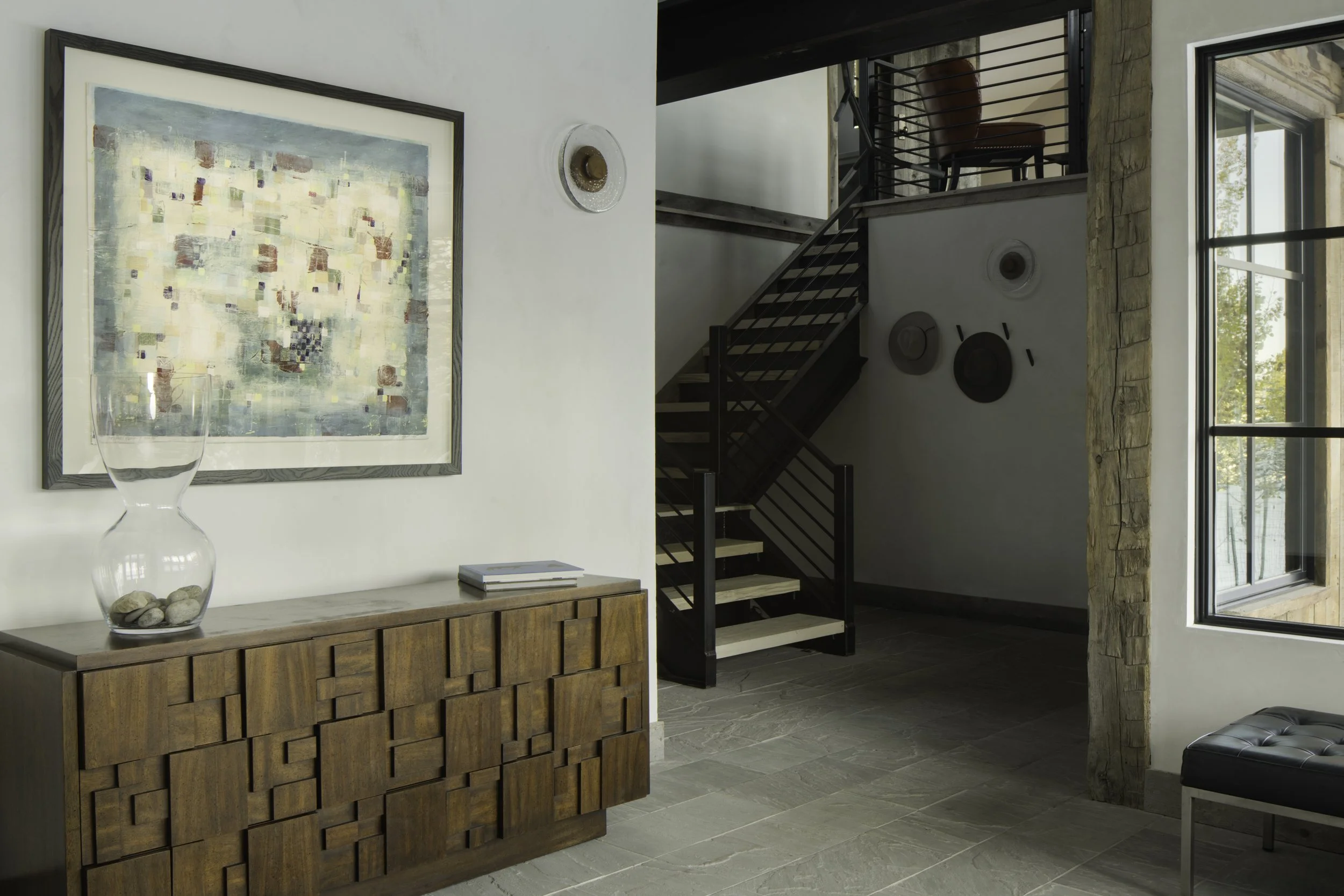 Entry with wood staircase and console table in Big Sky Montana