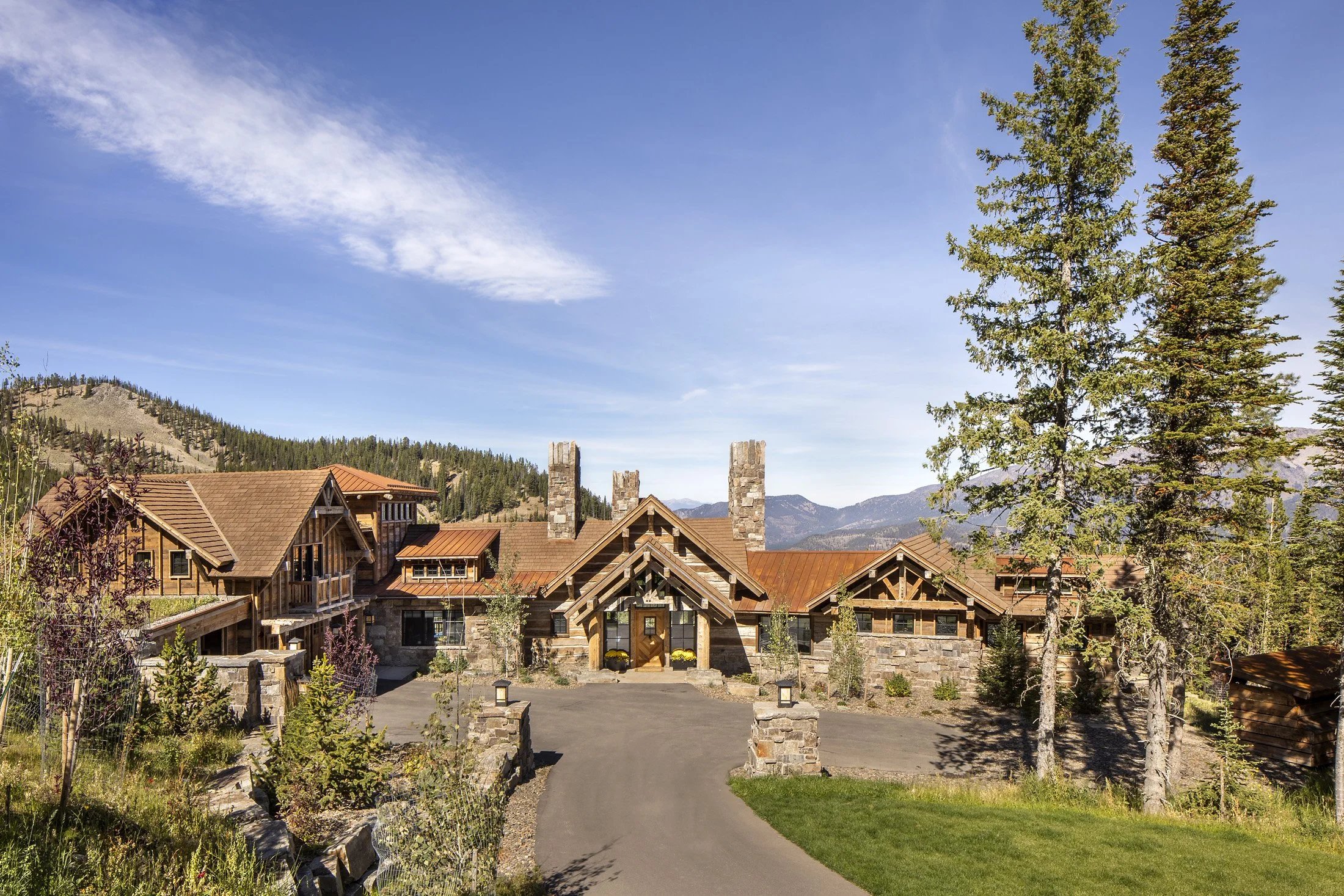 Drive approach with trees, mountain home in the summer