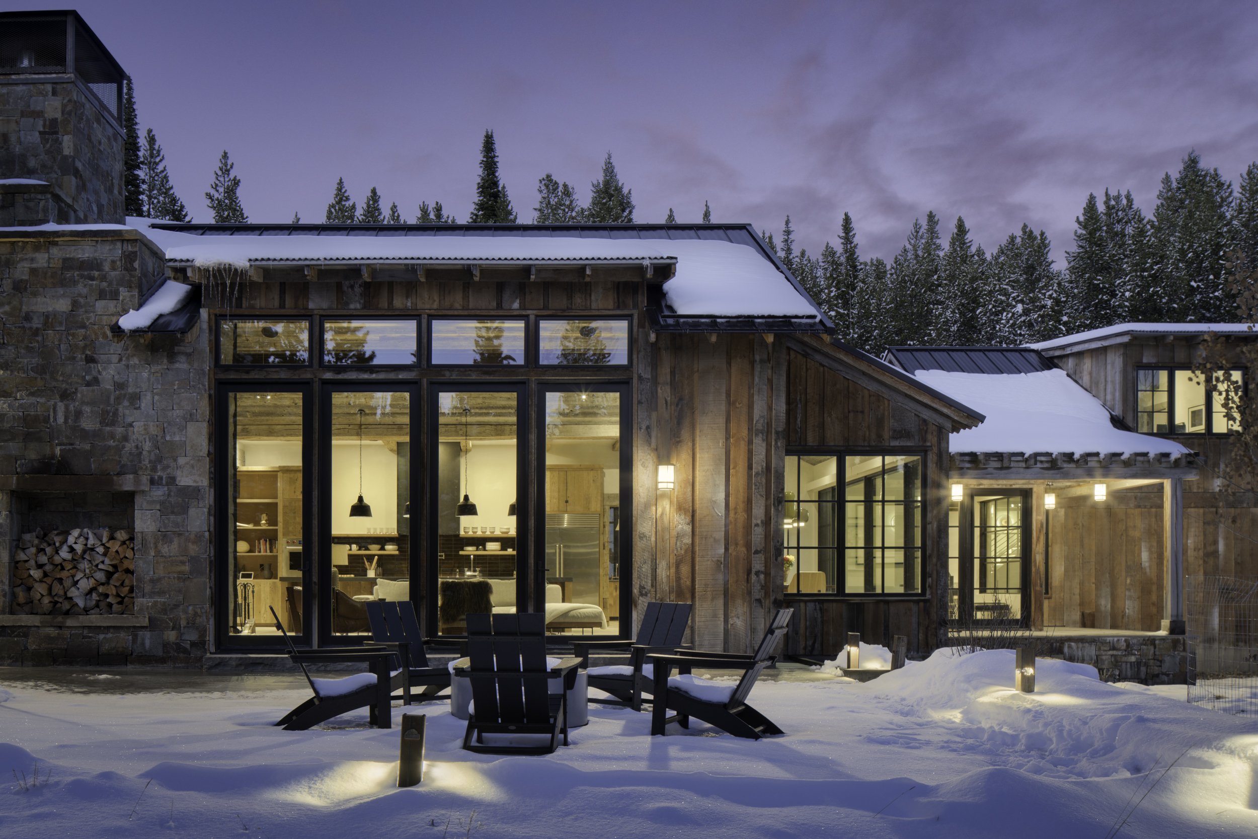 Home exterior with wood siding and stone base in Spanish Peaks Big Sky Montana