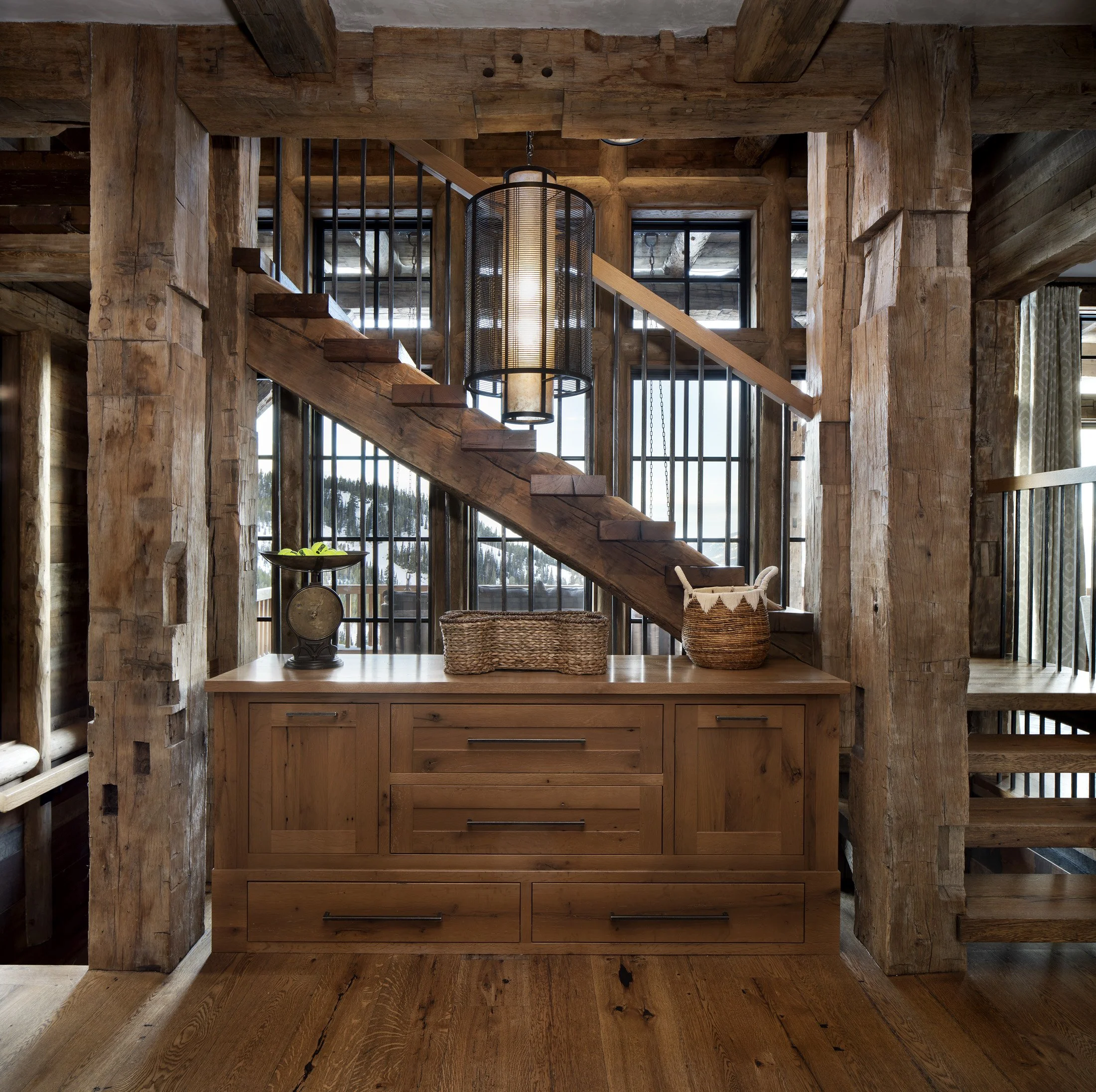 Stair detail with heavy timber structure, wood cabinetry, and interior framing
