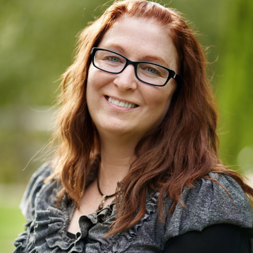 An image of therapist, Nicole Corbett, outdoors on a sunny day.