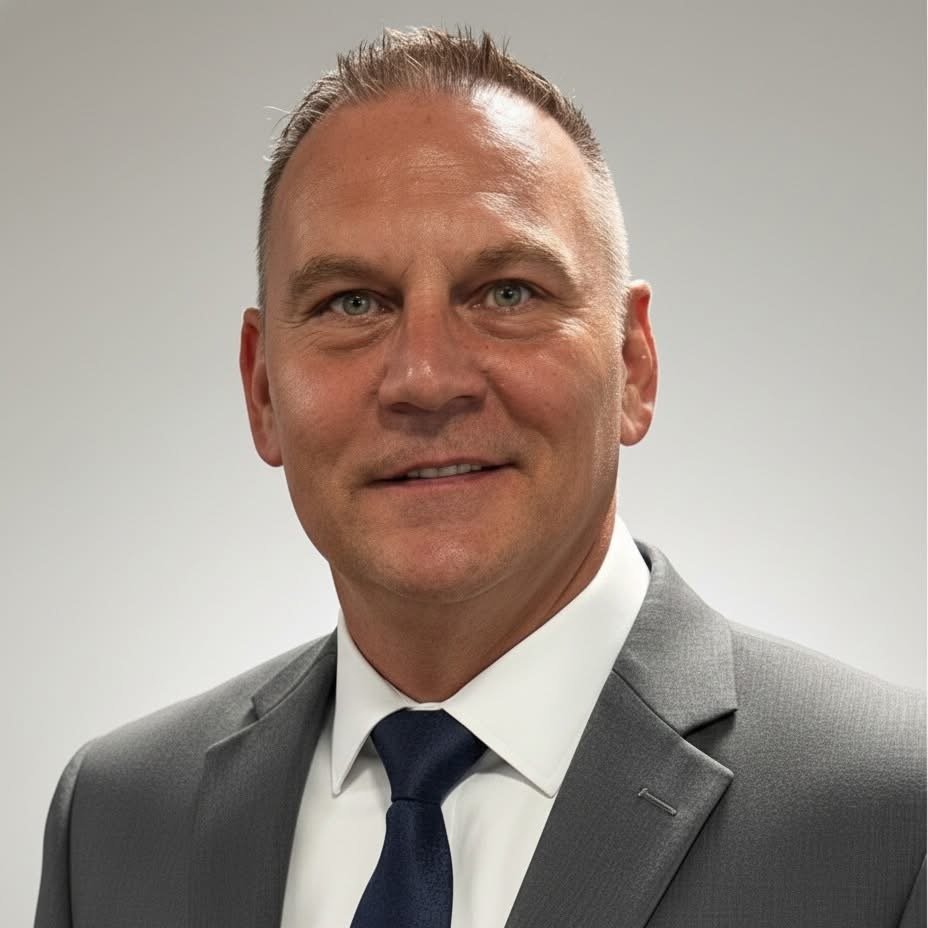 Photo of the CEO and founder of faith-centered recovery organization in professional gray suit headshot.