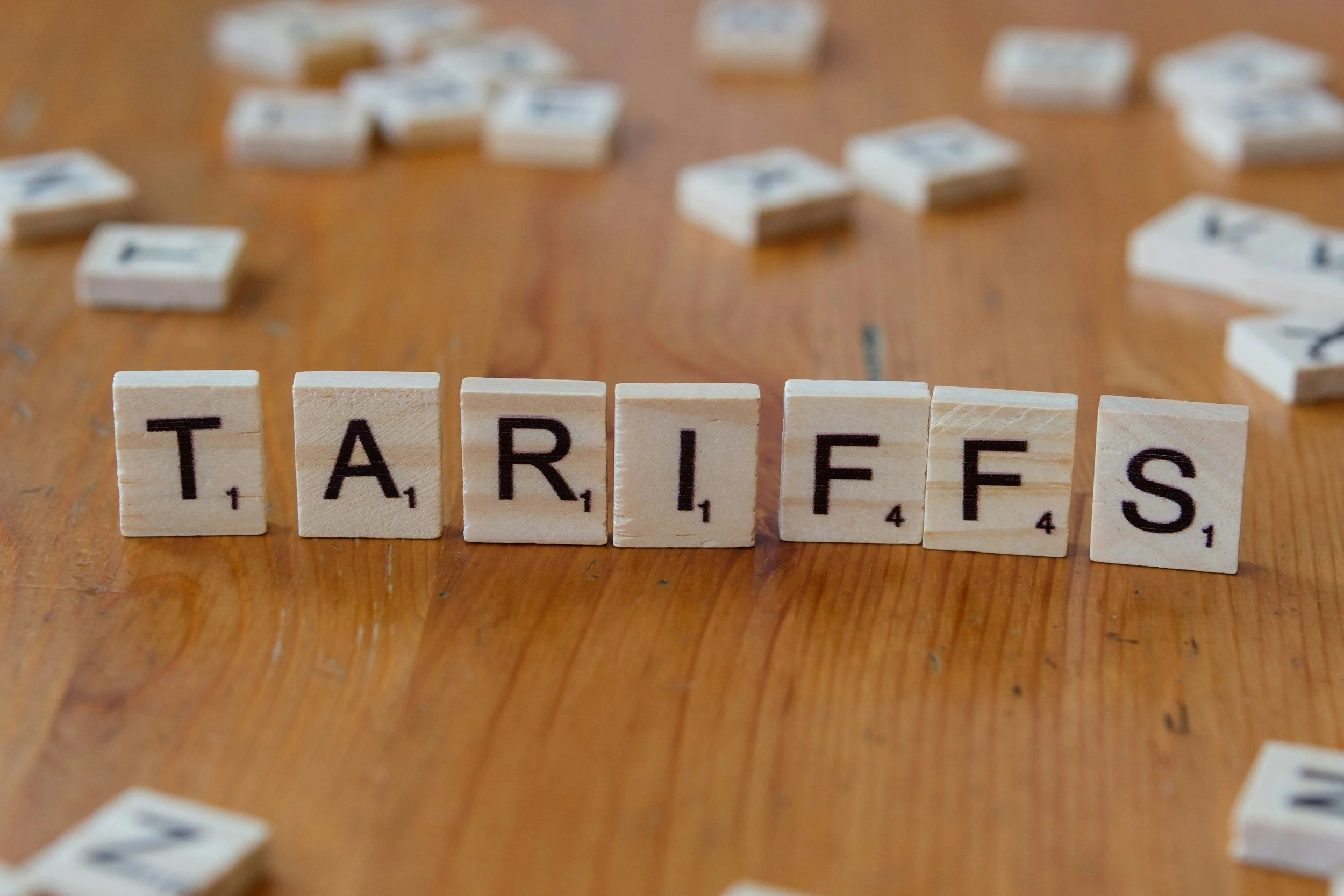 Letter tiles spelling the word tariffs. Fractional CFO for Amazon Sellers, E-commerce CPA, Amazon FBA Cash Flow Strategy