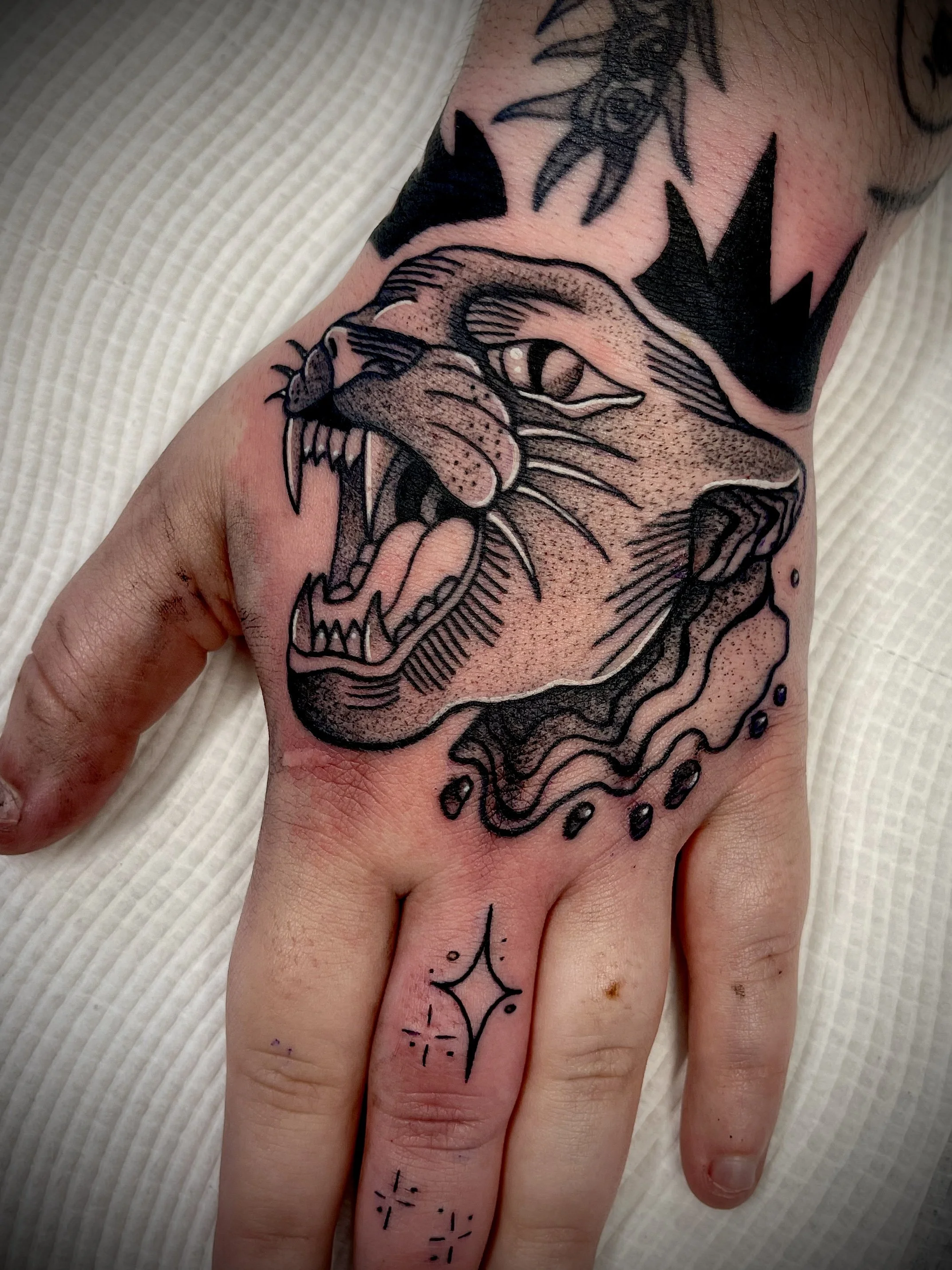 black and grey panther hand tattoo designed by Leasy Tattoo
