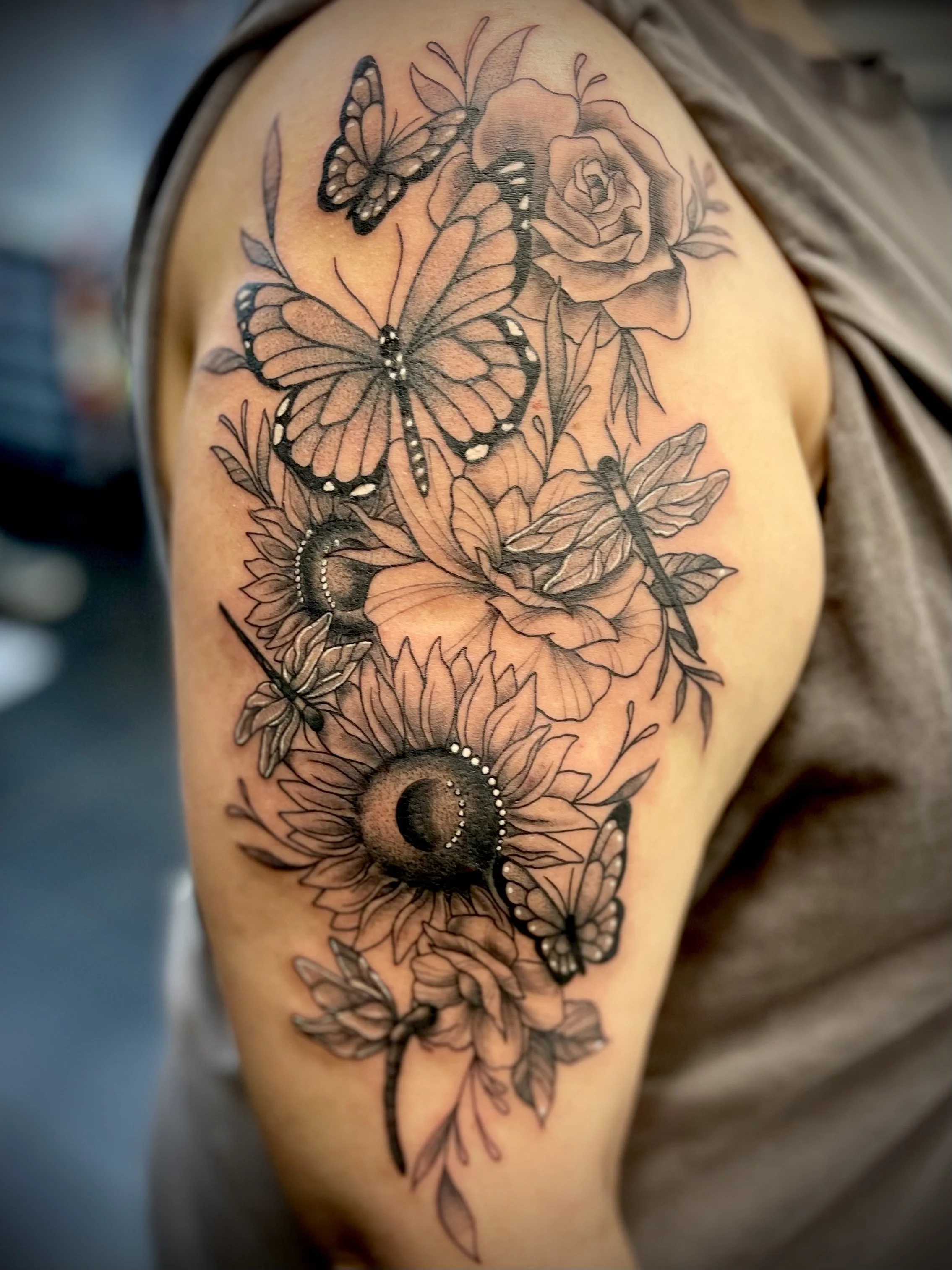 Black and grey floral butterfly tattoo designed by Leasy Tattoo