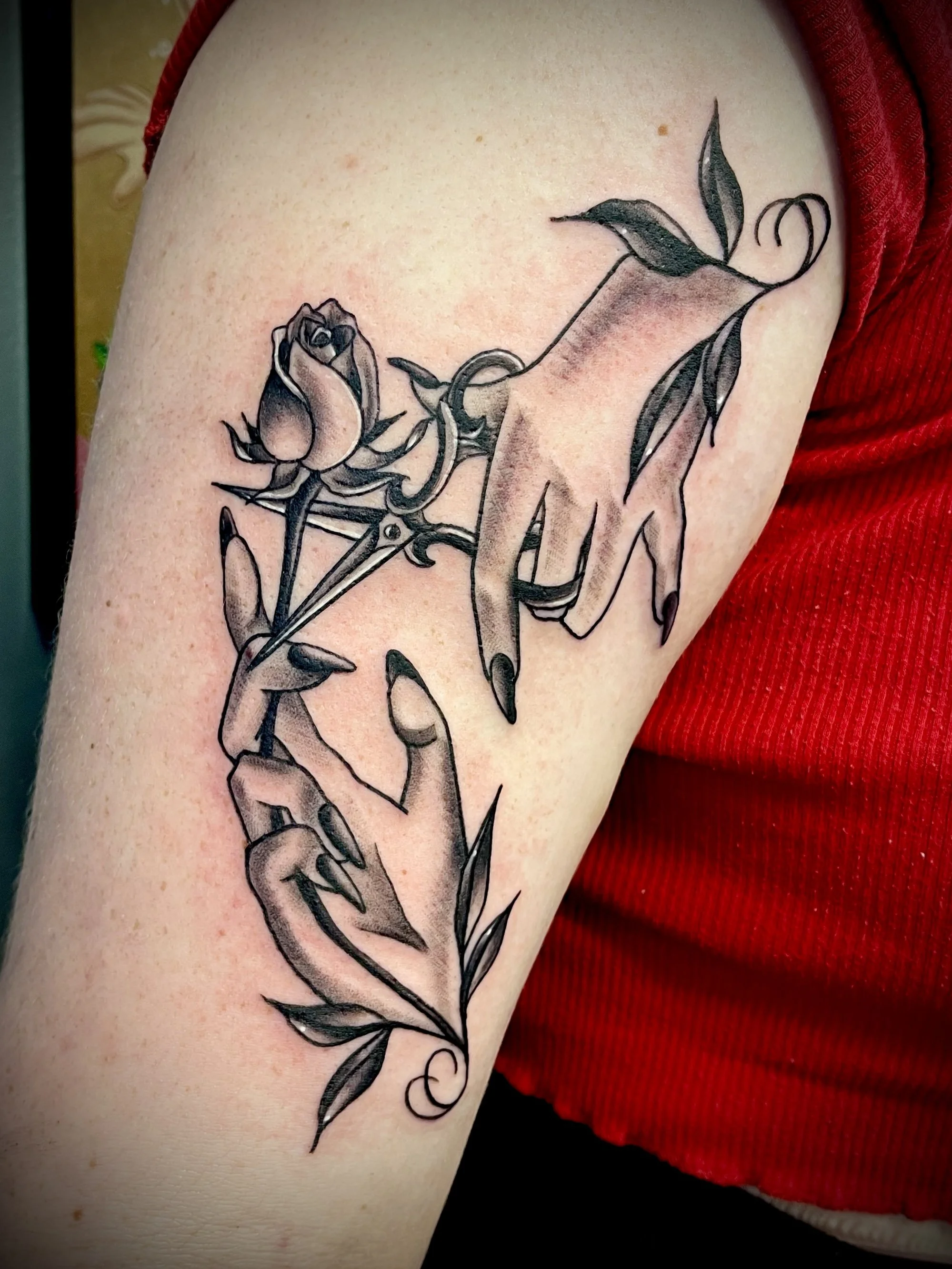Fine line black and grey hands with a rose tattoo designed by Leasy Tattoo