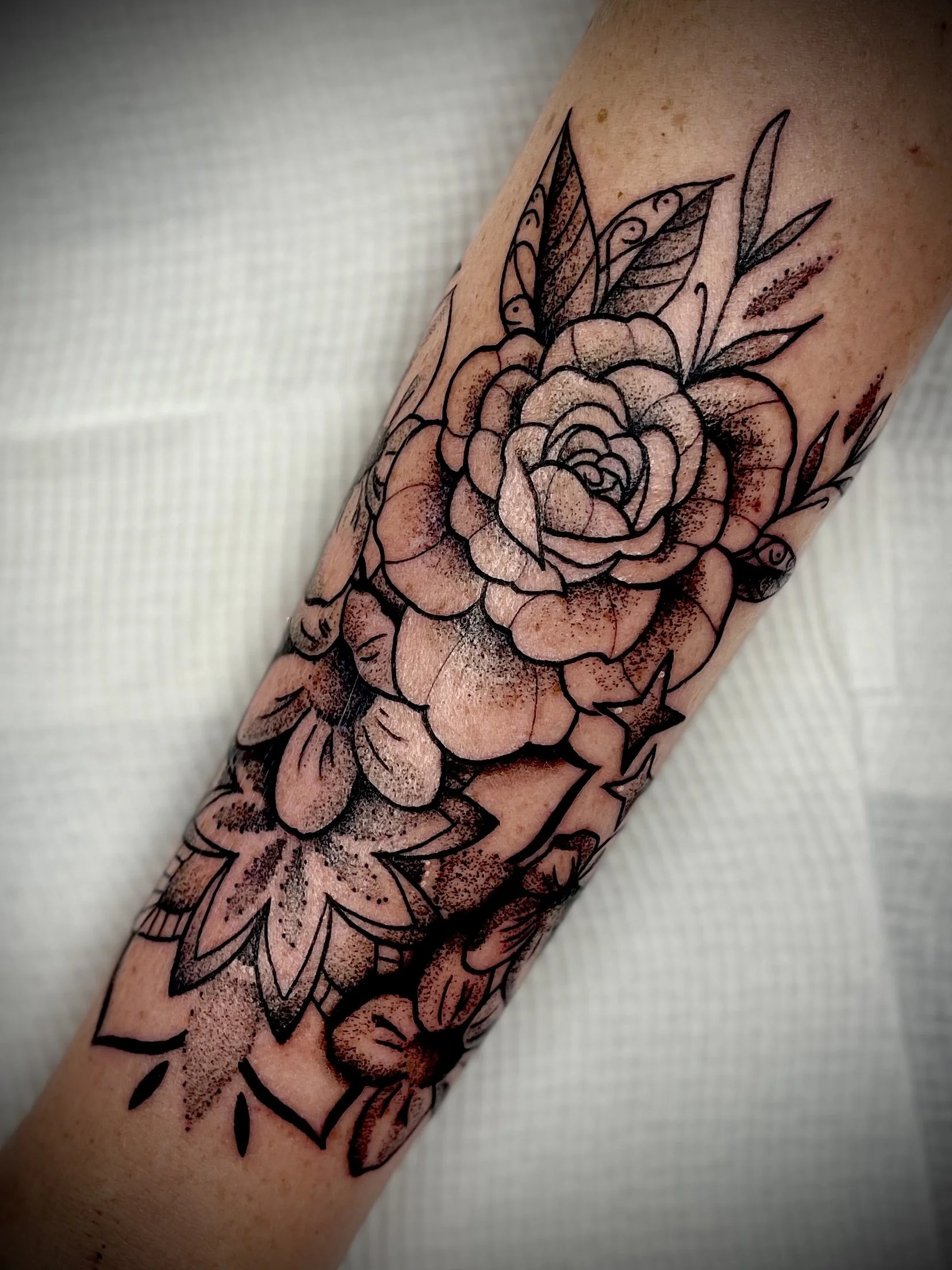 Fine line black and grey flower tattoo designed by Leasy Tattoo
