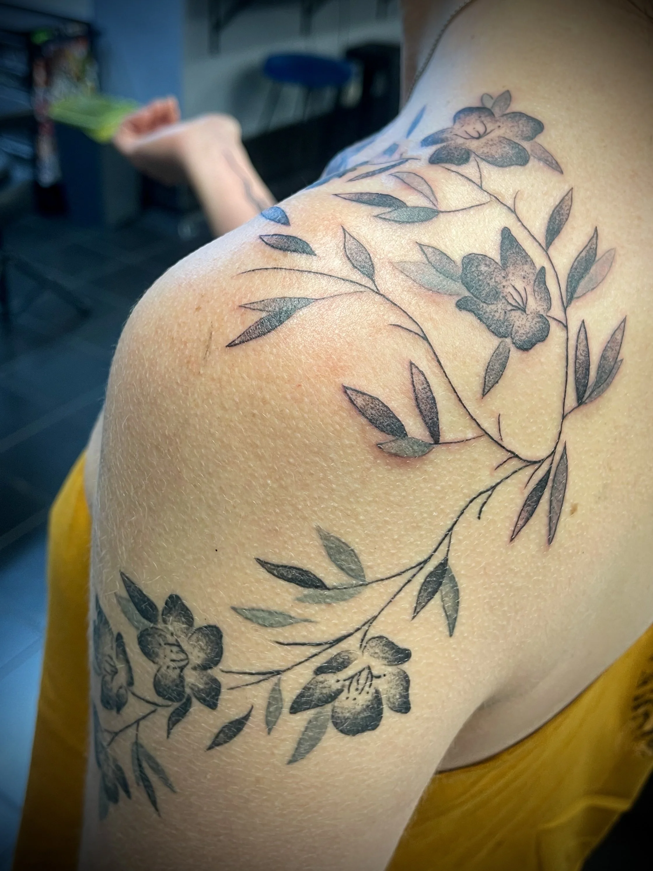Fine line black and grey floral vine tattoo designed by Leasy Tattoo