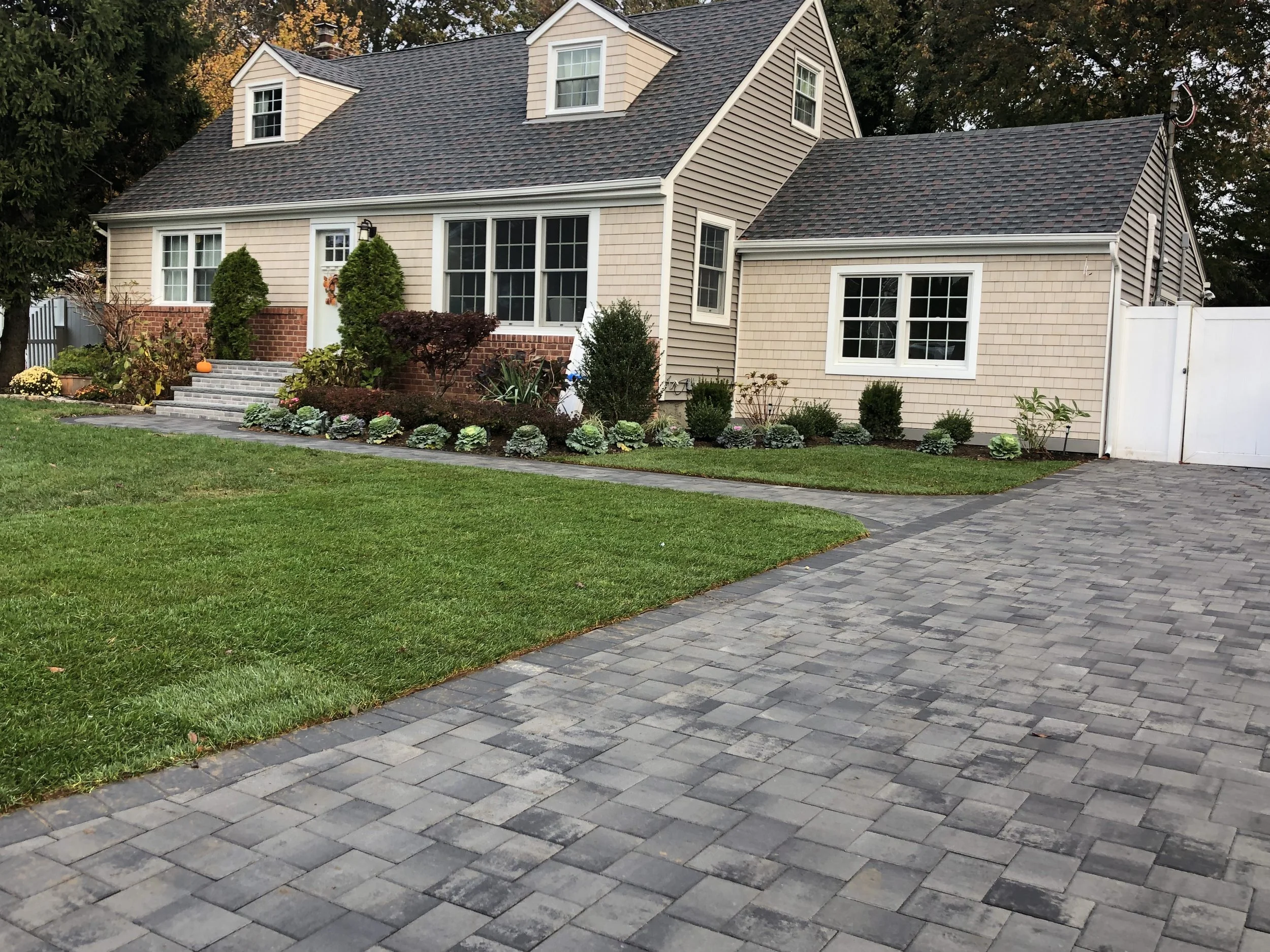 This is one of our latest work in Deer Park. New paver driveway. sod installation and seasonal flowers to add some winter decoration.