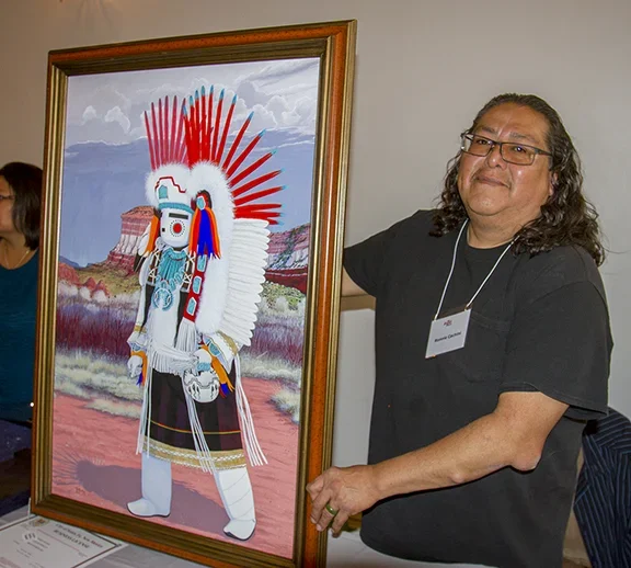 Ronnie Cachini with his painting at the Zuni Show