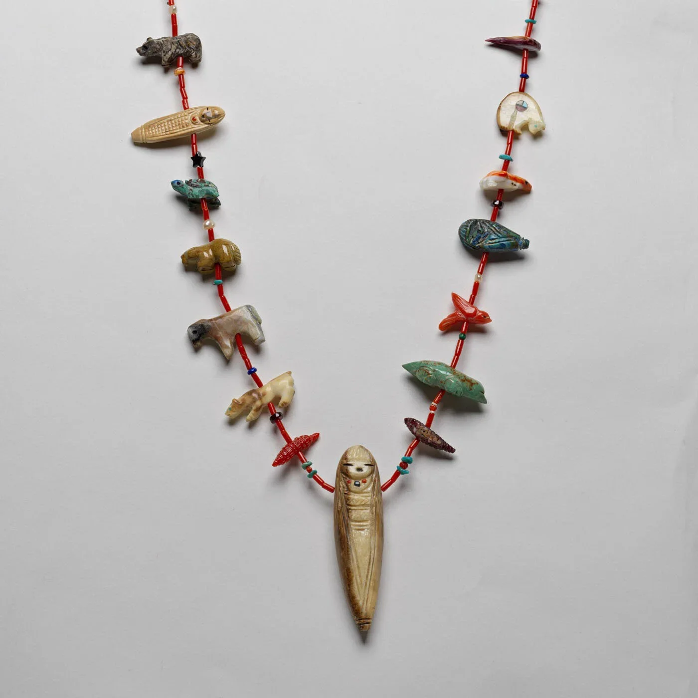 A necklace made of small, colorful, carved stone animals, grandmother and birds made by Quandelacy Family.