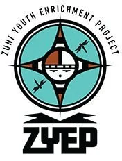 Logo of Zuni Youth Enrichment Project with a Zuni figure, in black, white, and teal colors.