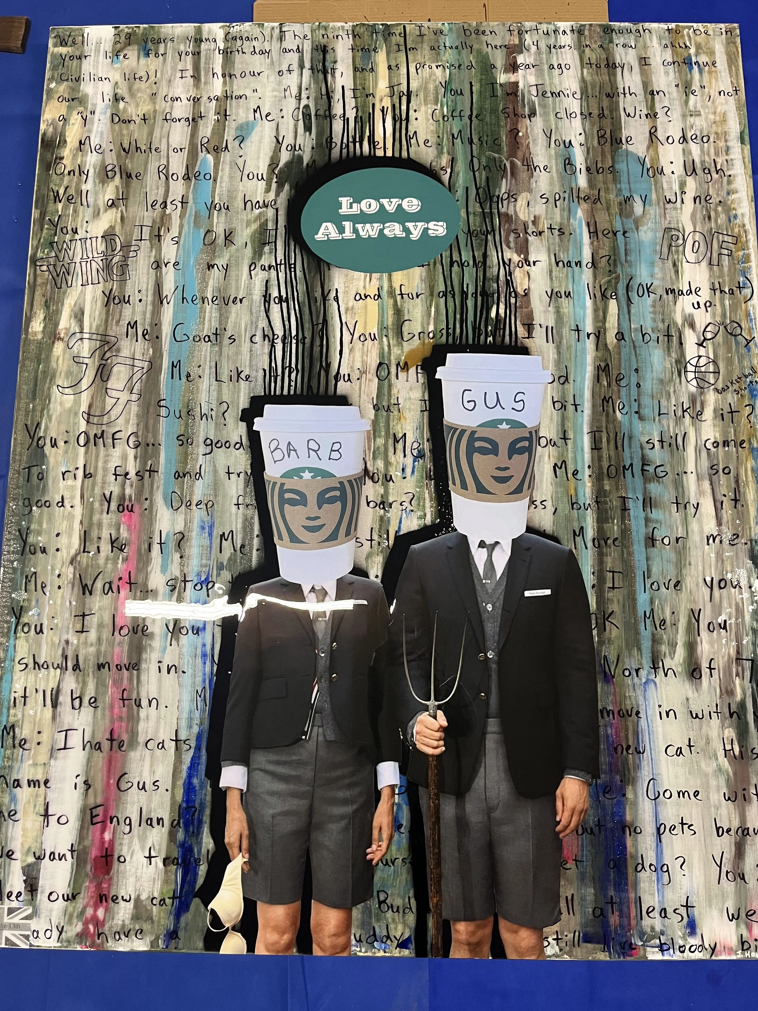 A wall covered with handwritten messages and doodles, with a large circular sign that says 'Love Always' at the top center. In front are two cutouts of people dressed in business attire with coffee cup heads labeled 'Barb' and 'Gus,' standing side by