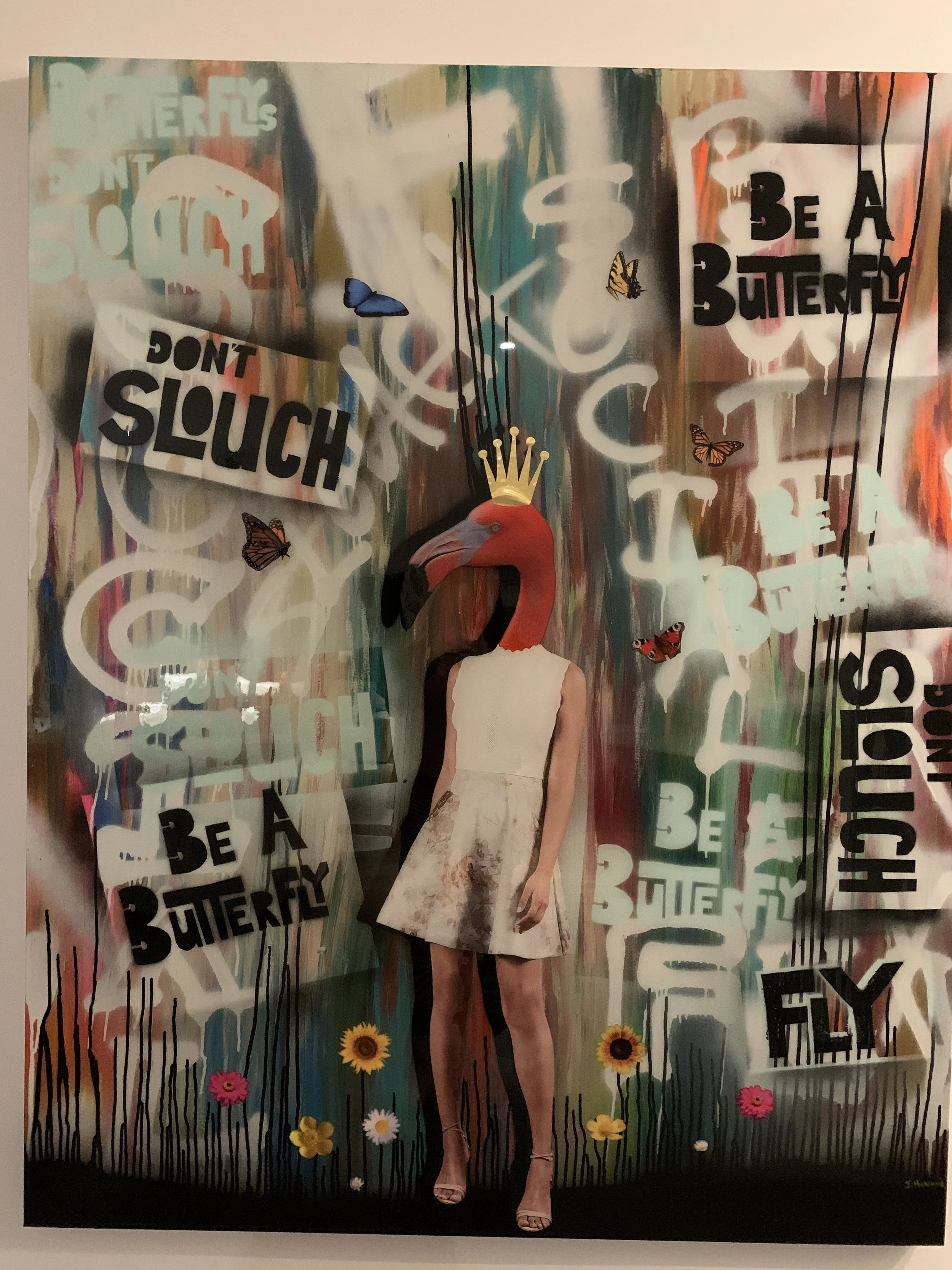 Mixed media collage artwork featuring a person with a flamingo head wearing a crown and a white dress, against a colorful, graffiti-style background with butterflies, flowers, and bold text saying "Don't Slouch" and "Be a Butterfly."