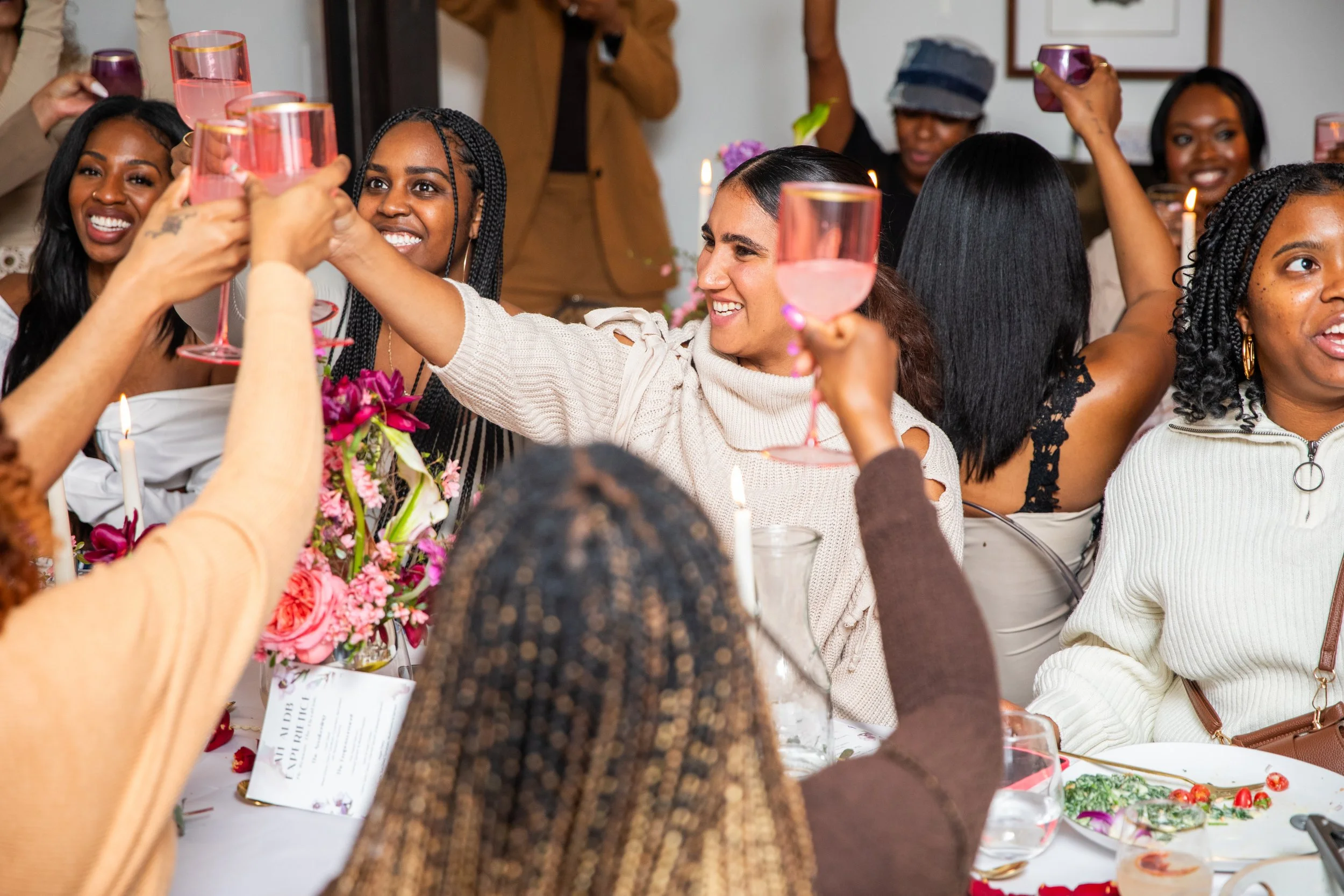 Women toasting at Curated Brunch and Wellness Retreat